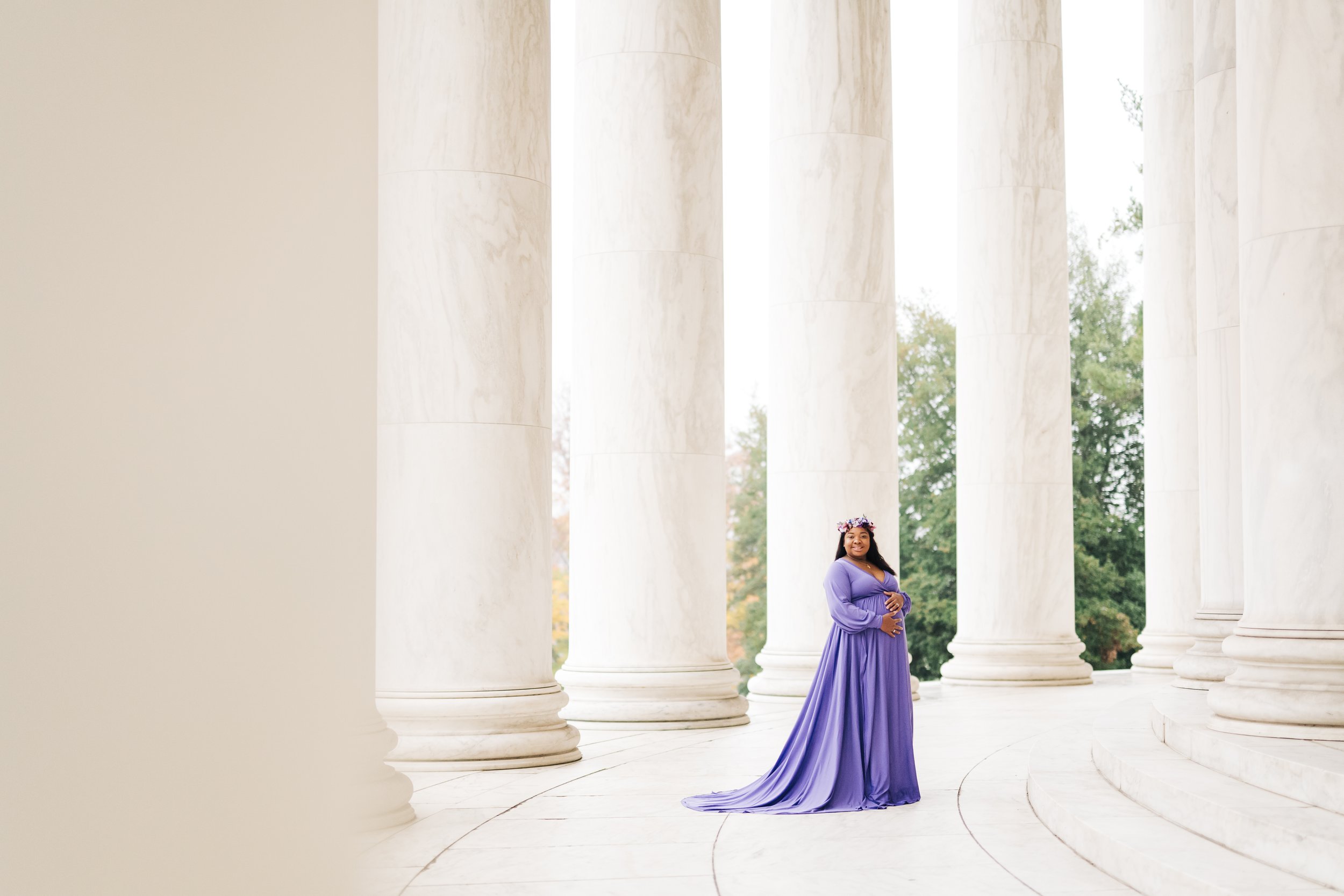 Pregnant woman in lavender maternity gown at Jefferson Memorial in Washington DC