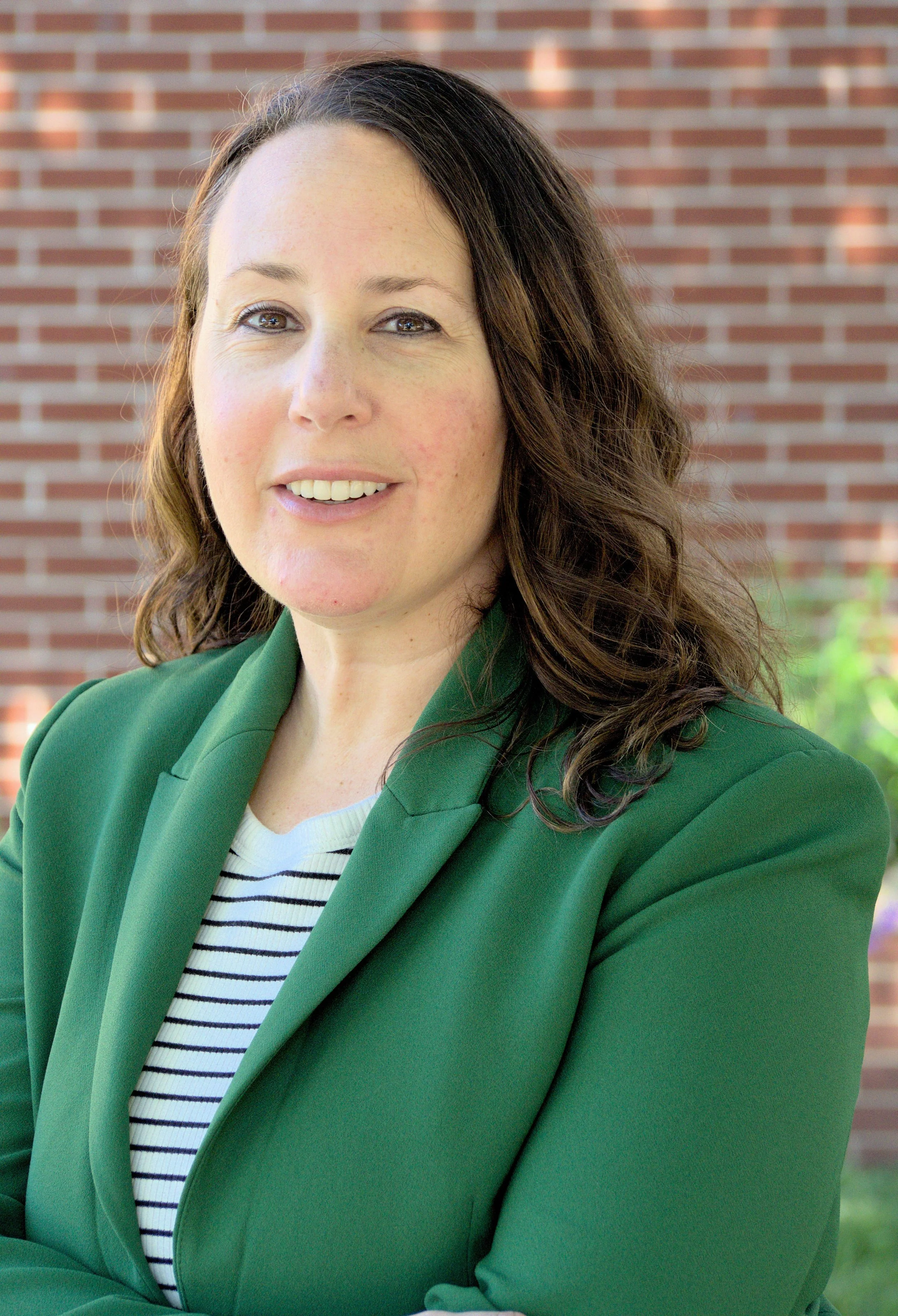 Photo of female provider against brick background (Copy)