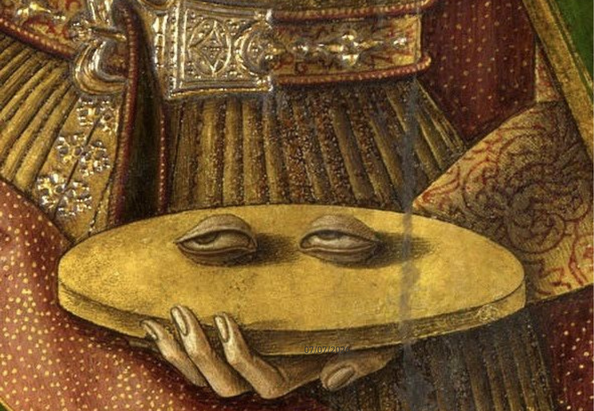 A close-up photo of a carved wooden sculpture of a serene face with closed eyes, adorned with detailed patterns and embellishments, possibly a cultural or religious artifact.