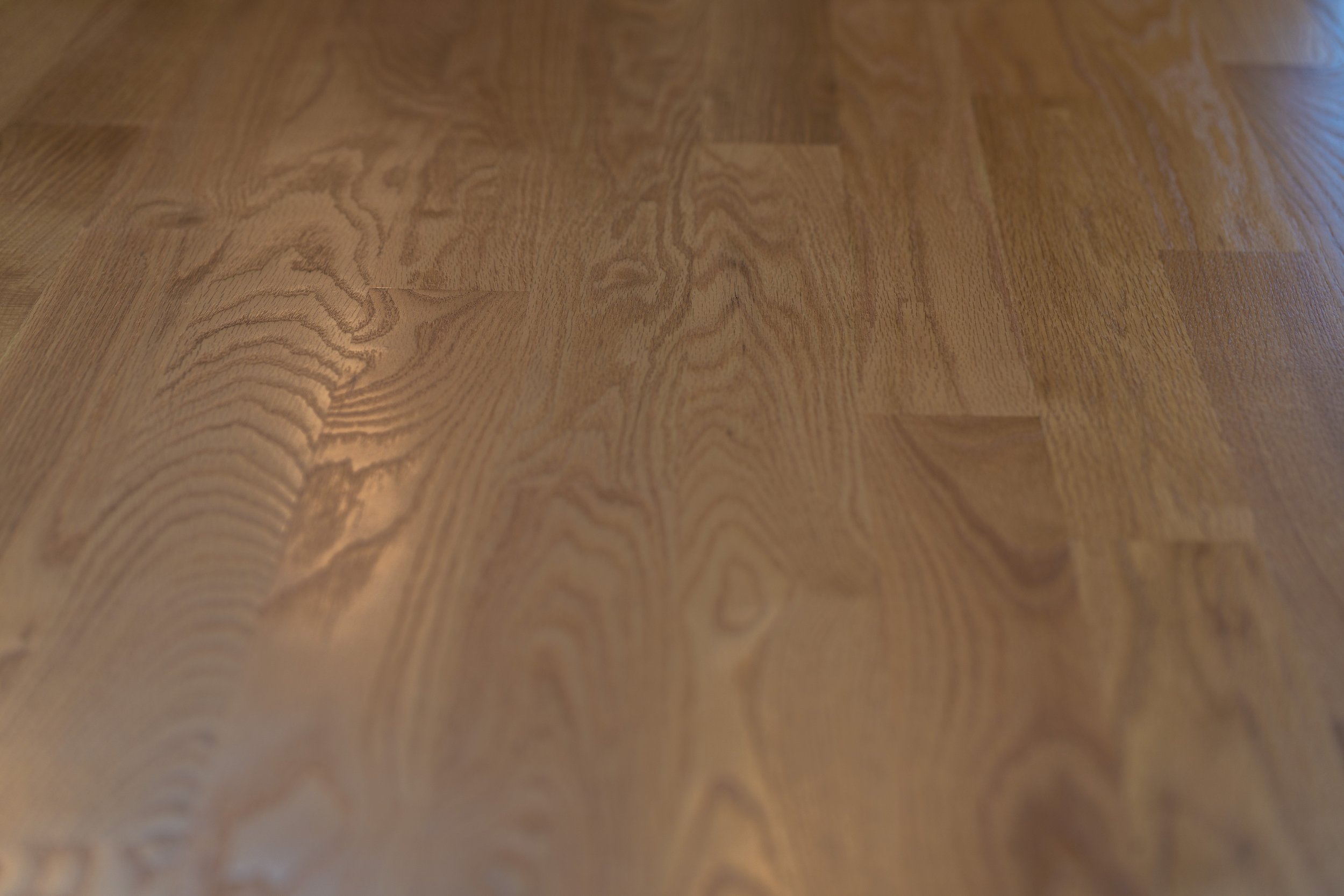 Close-up of a wooden surface with a natural wood grain pattern.