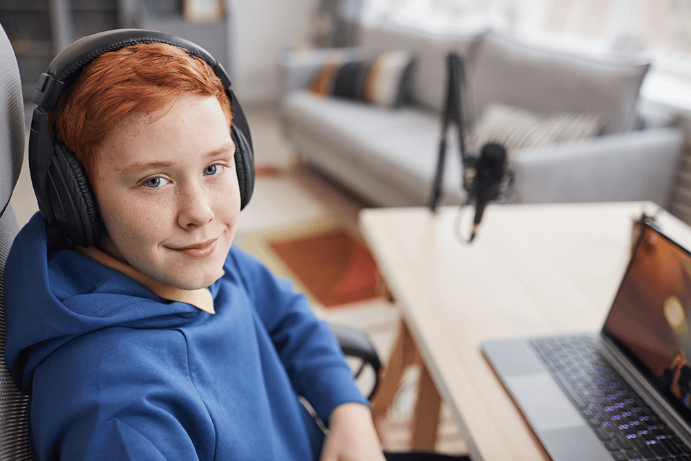 smiling-red-haired-boy-playing-video-games-M58AQ7V.png