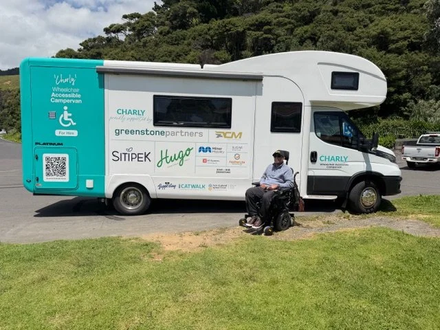 Yashlin in his power wheelchair in the front of Charly.
