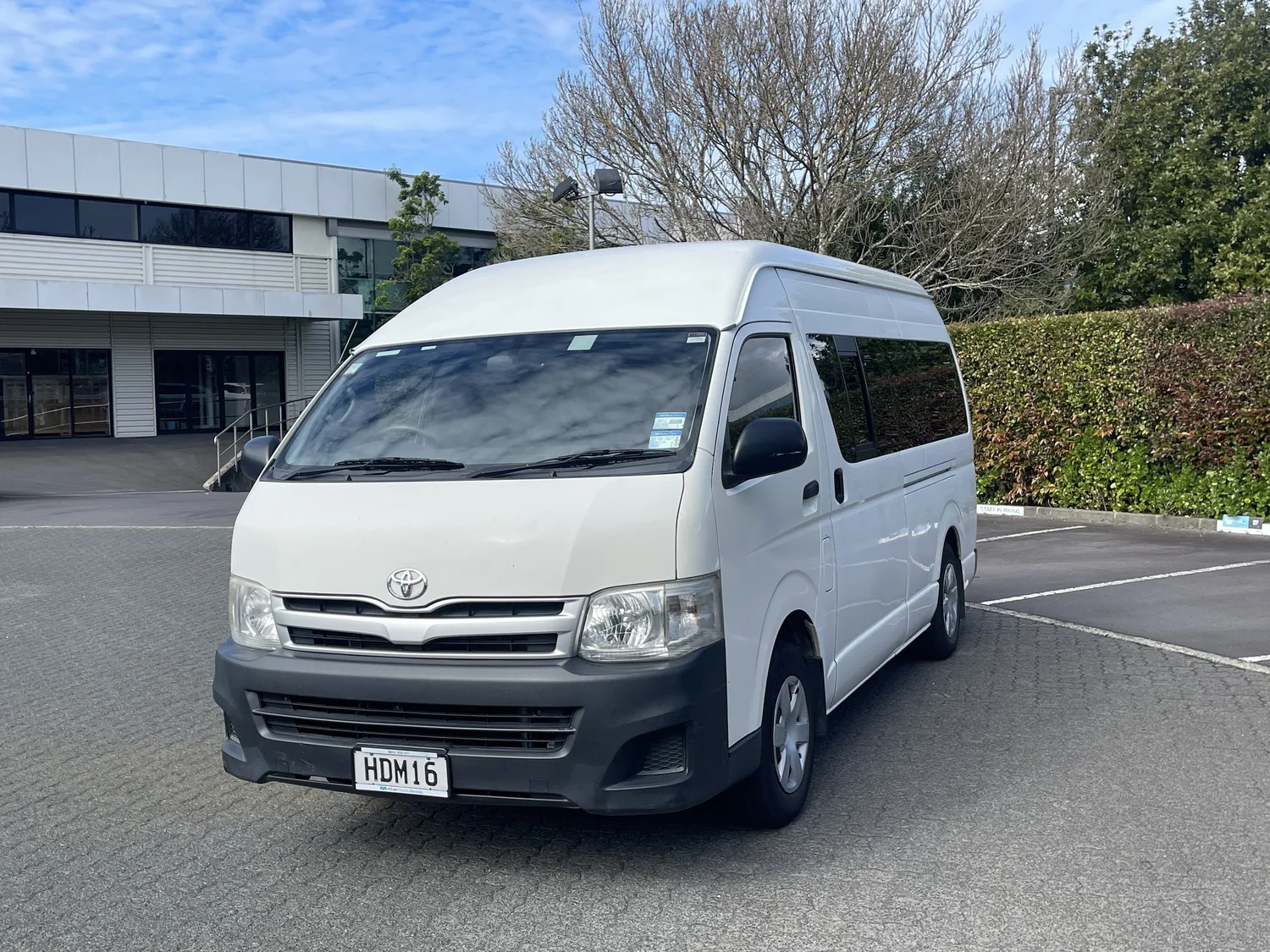 Toyota Hiace high-roof, white, front three-quarter exterior view