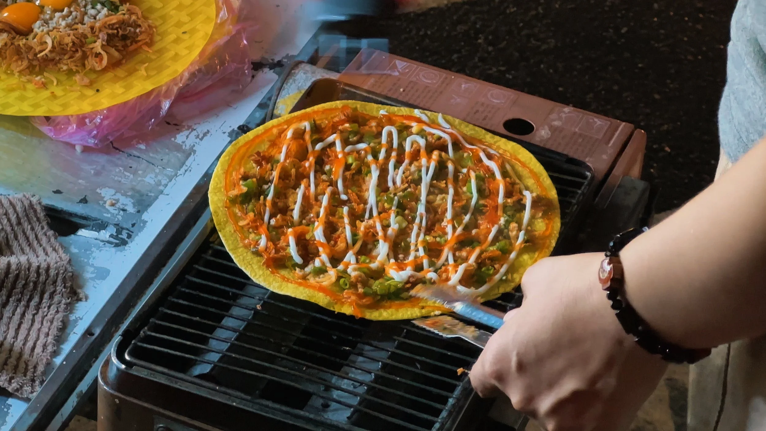 Street food in Ho Chi Minh City banh trang nuong Vietnamese pizza