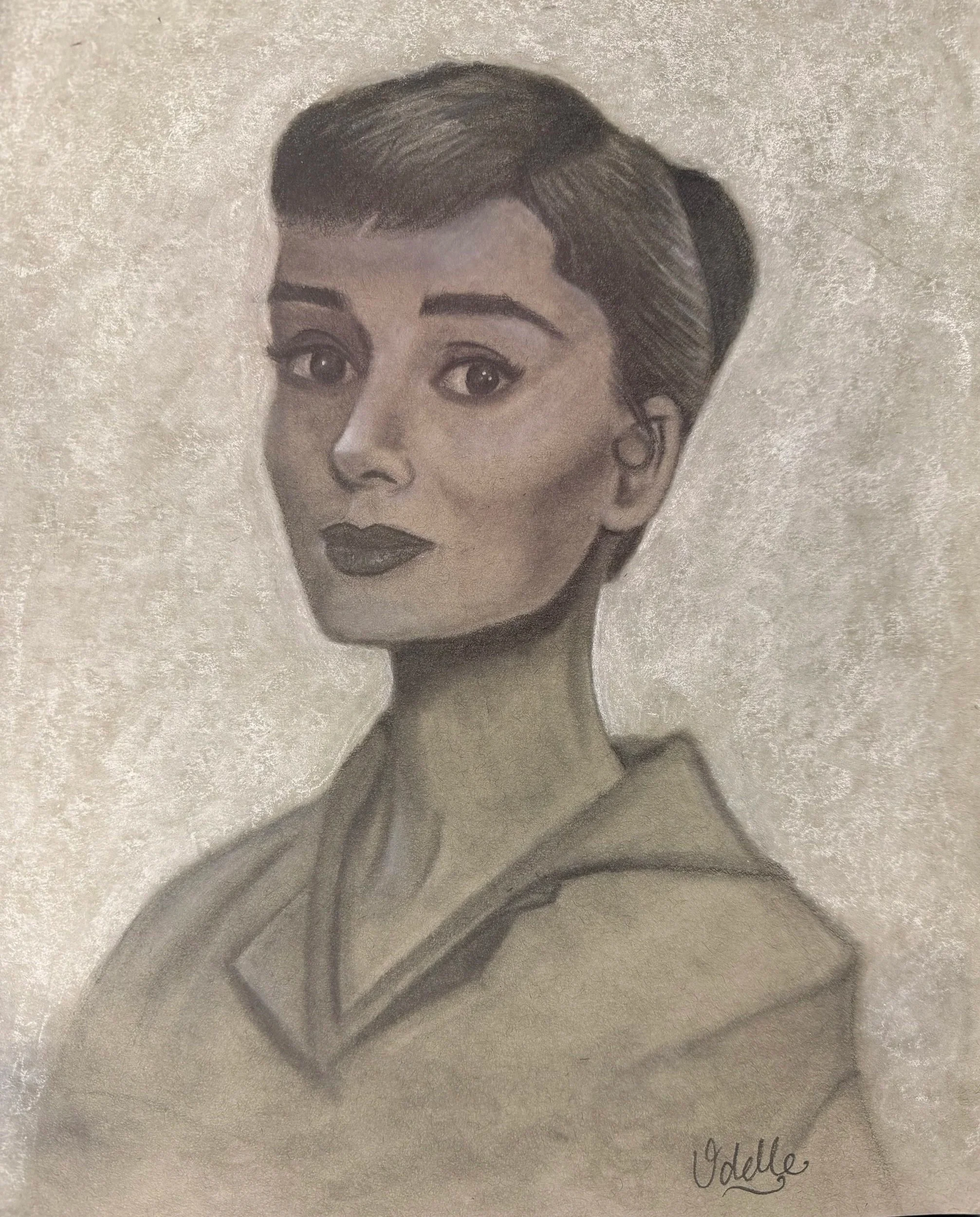 A pencil drawing of a woman with short hair, dark lipstick, and a hoodie, signed by Odette.