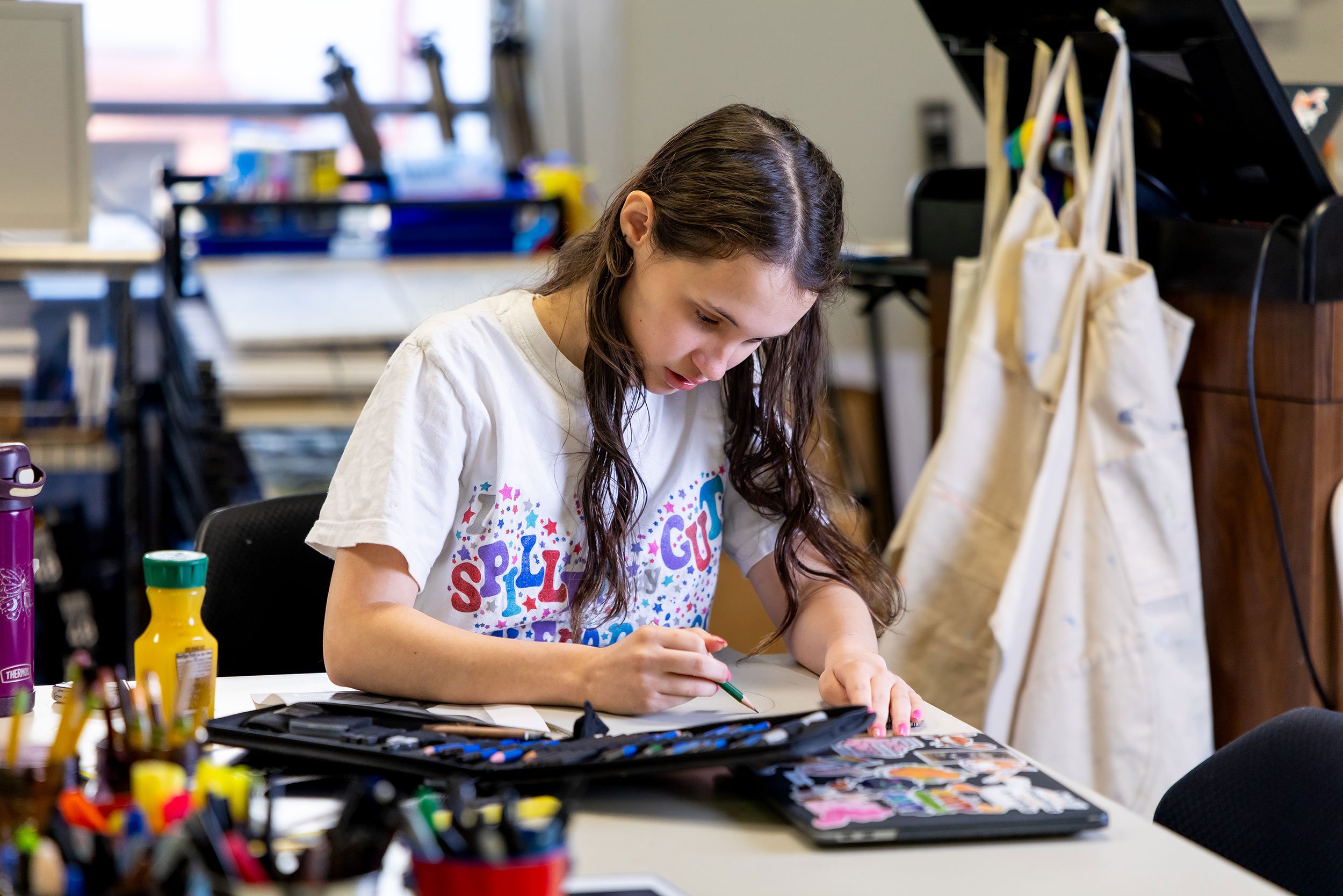 Student works on drawing in art classroom.