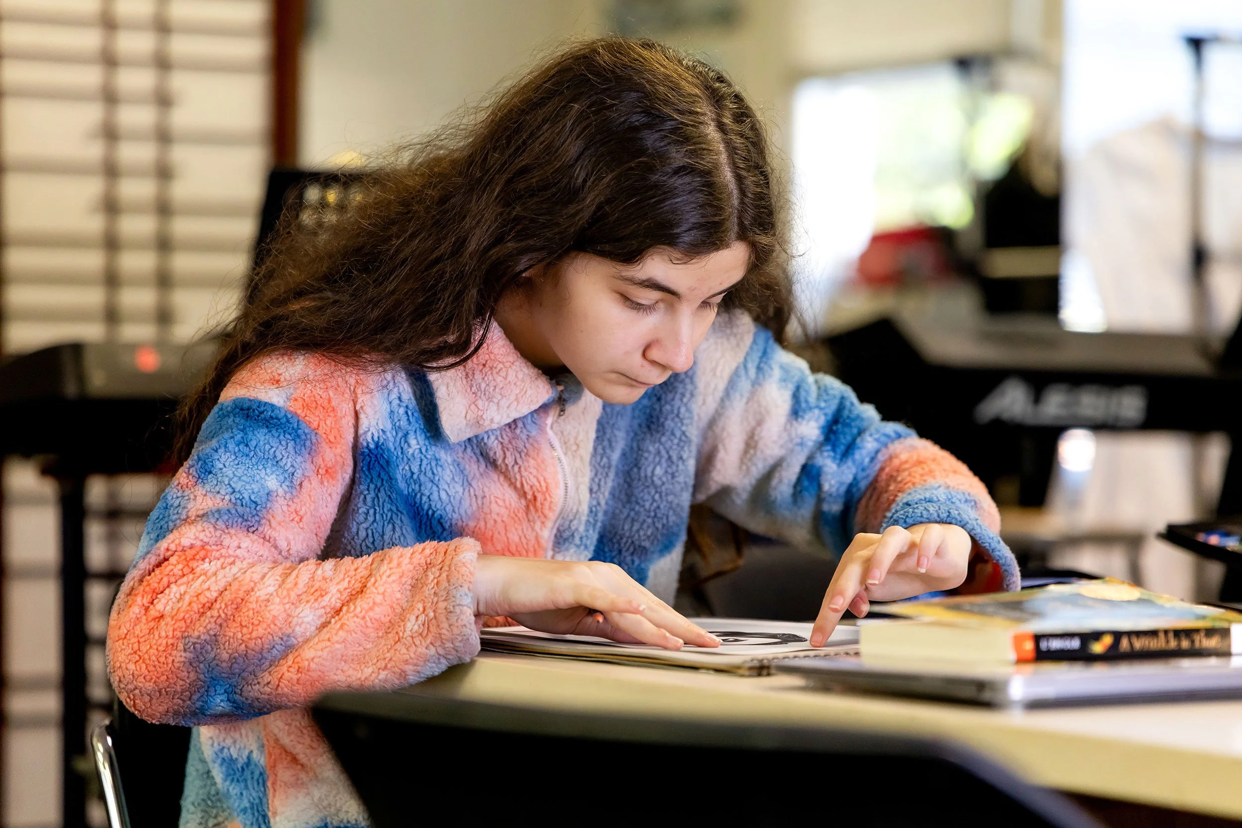Compass student works on art project in classroom