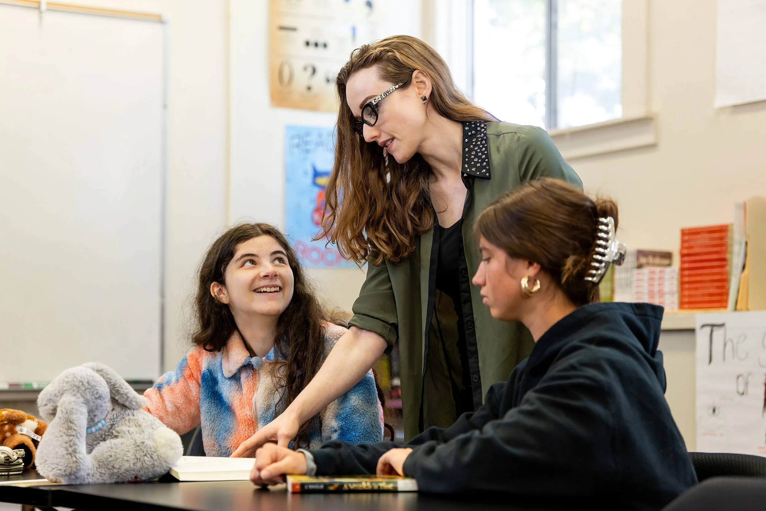 Compass teacher and two students work in classroom.
