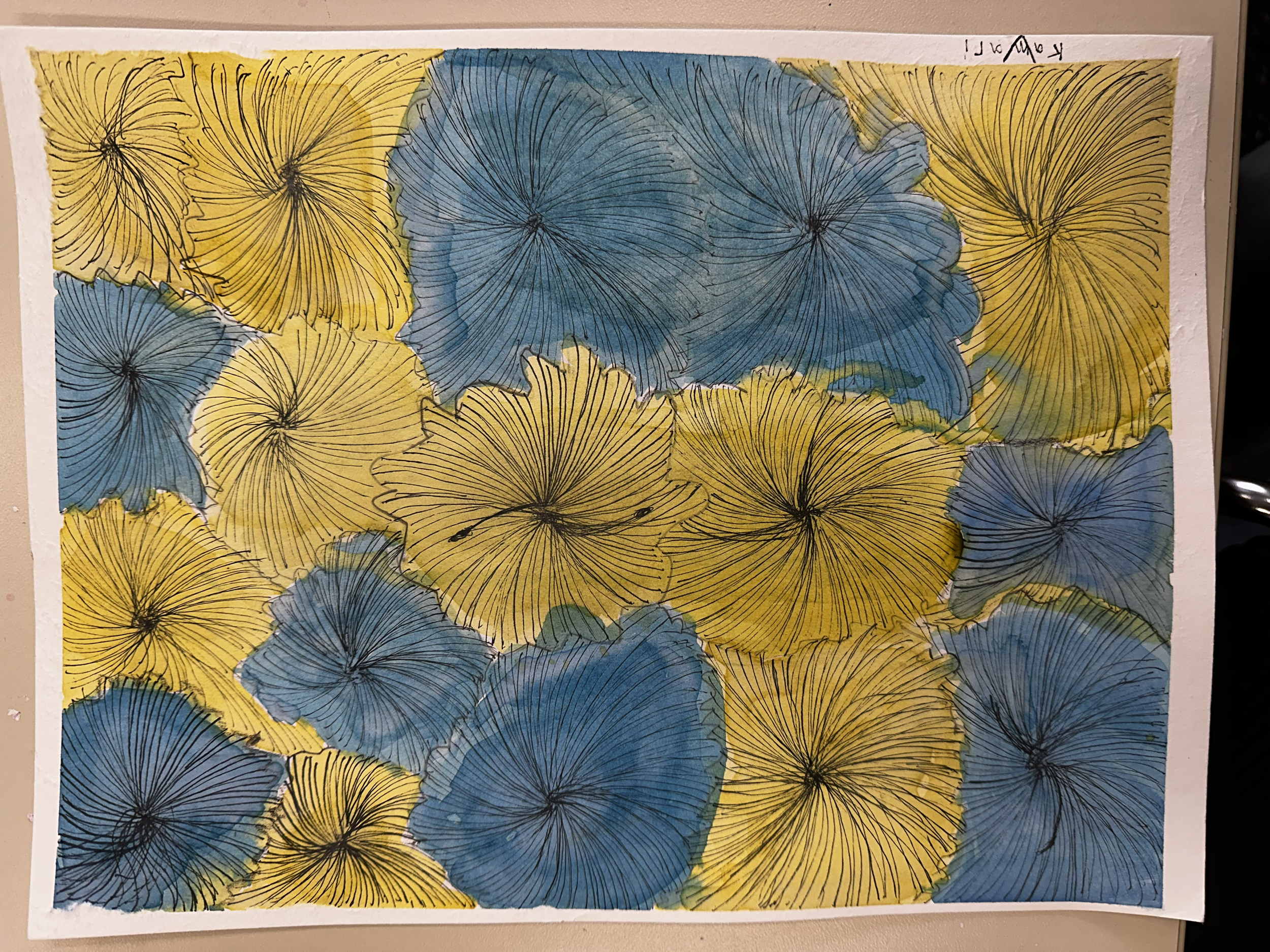 A piece of artwork with an abstract floral pattern of overlapping yellow and blue flowers with black outlines on white paper.
