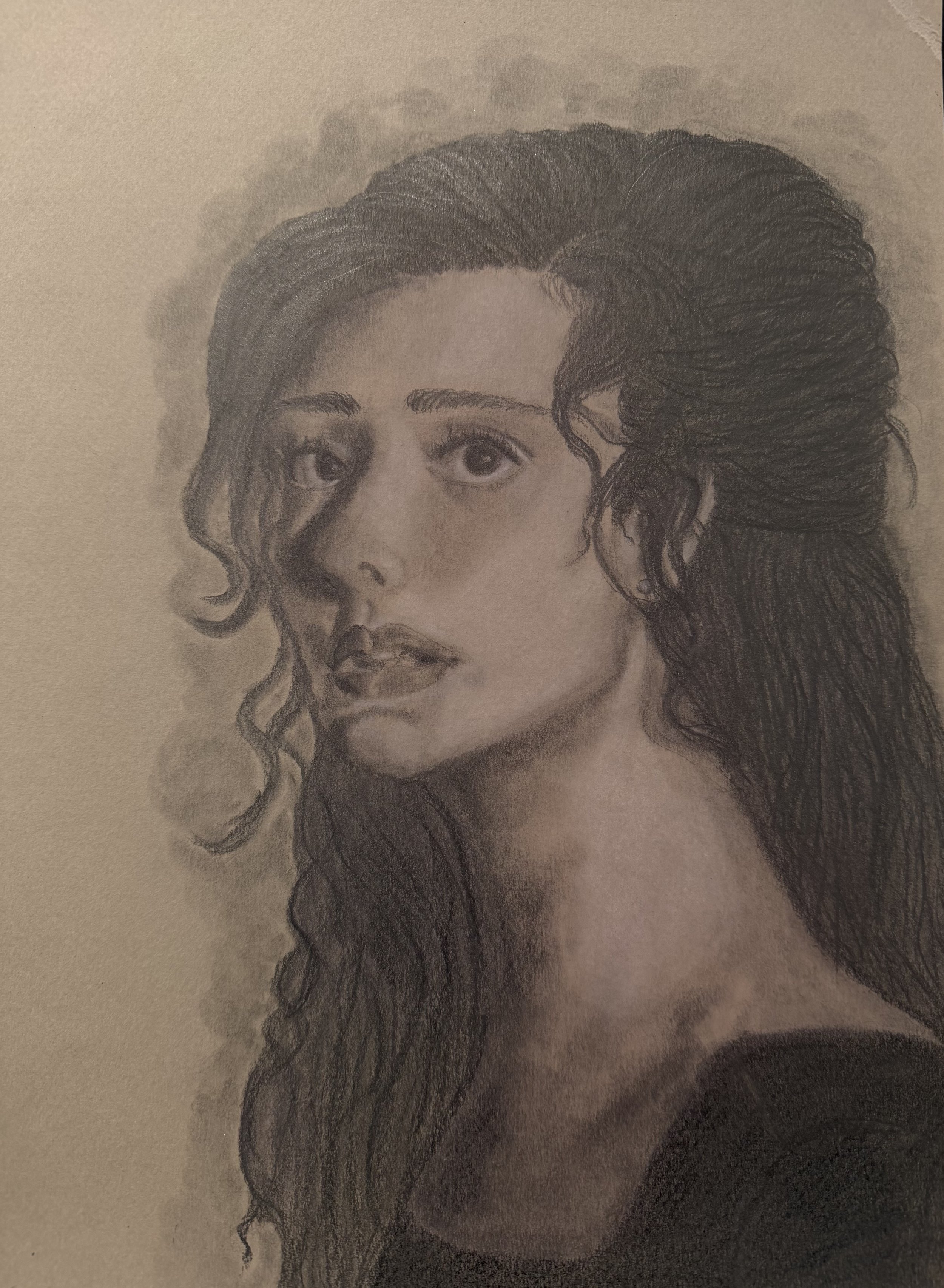 A realistic pencil sketch of a woman with long, wavy hair and expressive eyes, looking slightly to the side.