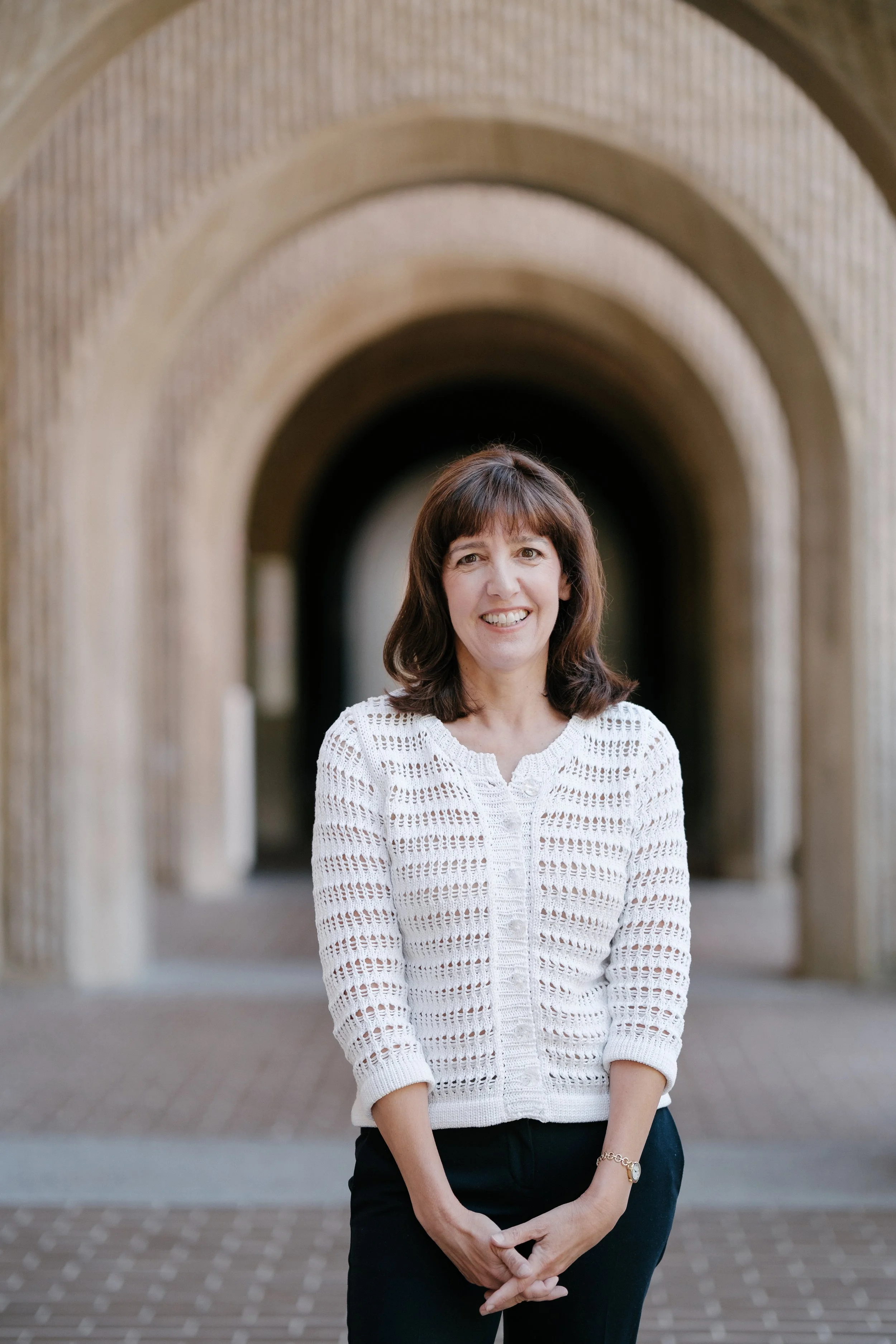 Dr. Denise Pope, Stanford University senior lecturer and co-founder of Challenge Success, standing outdoors on campus.