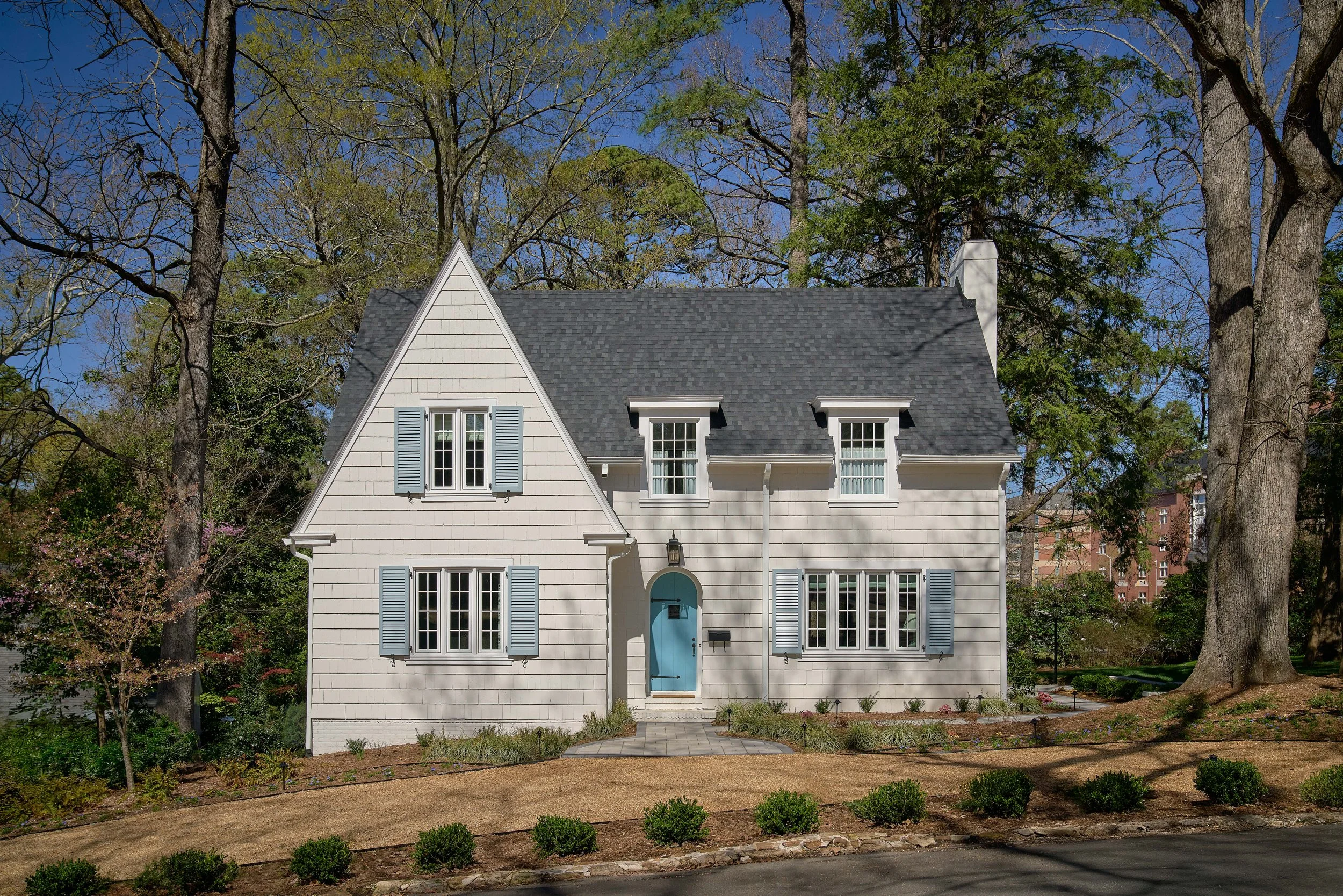 white cottage house with blue door in chapel hill renovated and designed by cat french design chapel hill interior designer durham interior designer