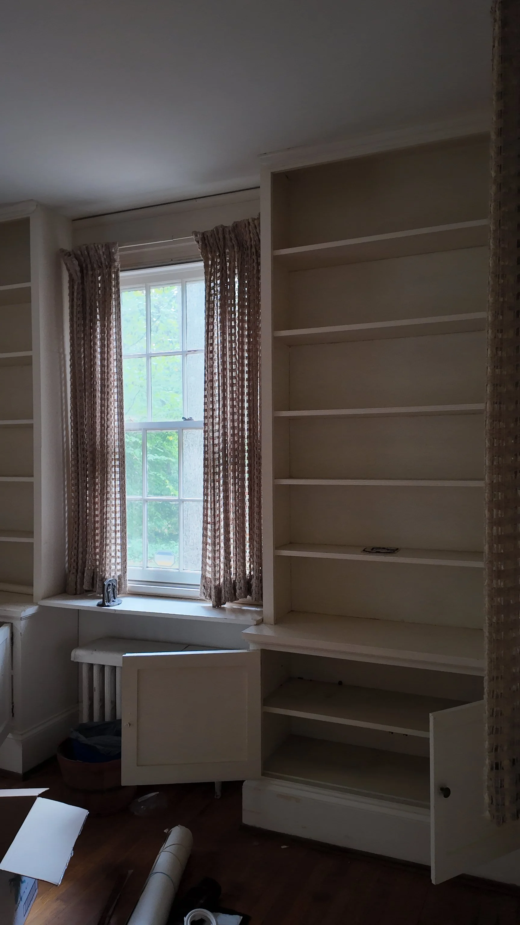 home library with window and built-in shelves and cabinets in historic chapel hill home renovation by cat french design chapel hill historic neighborhood