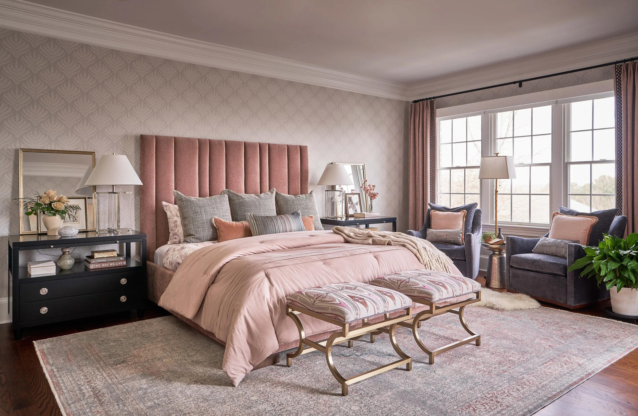 large bedroom with pink custom bed and headboard ornate footstools and blue swivel armchairs luxury townhome design in chapel hill by cat french design chapel hill interior designer durham interior designer