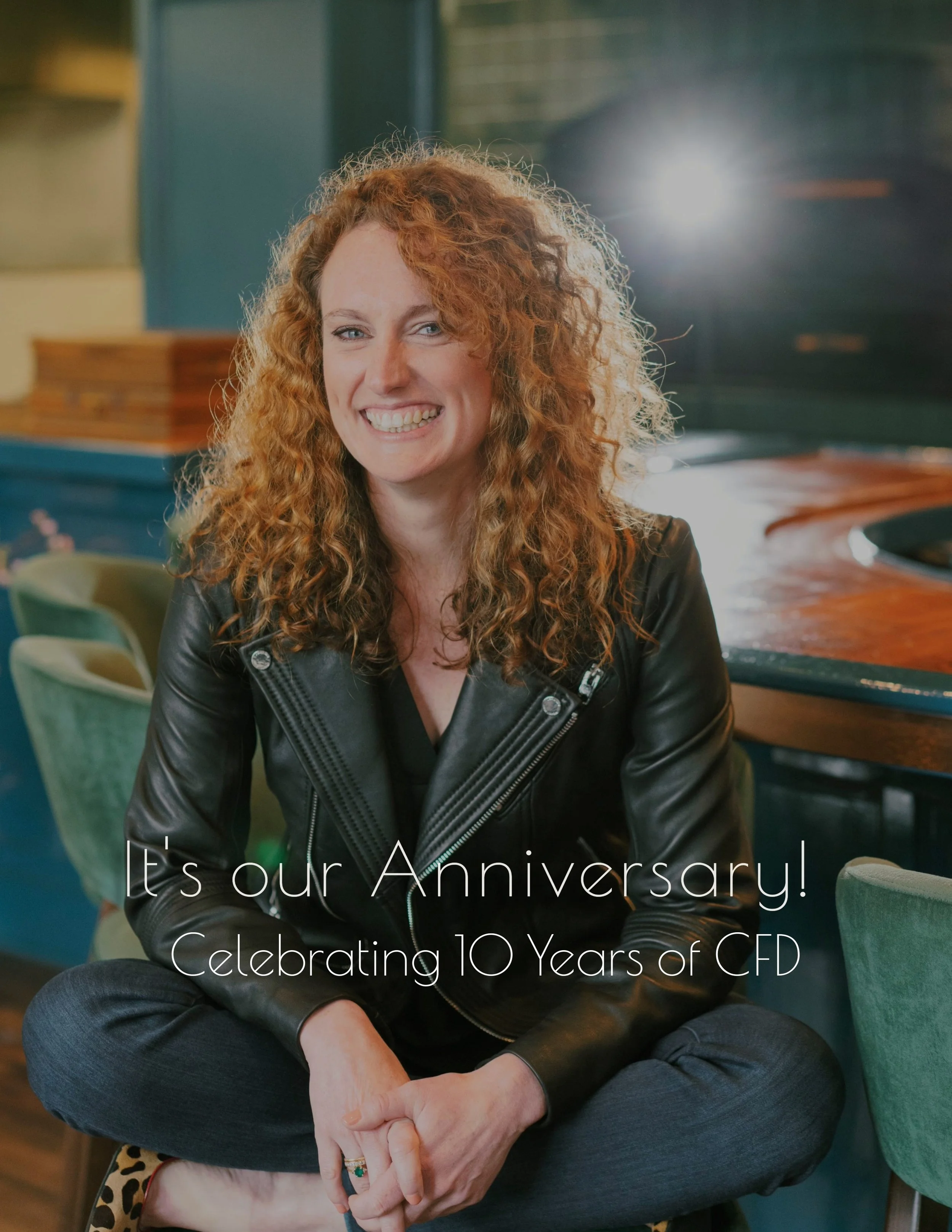 Cat French Chapel Hill interior designer sitting in a restaurant celebrating 10 year anniversary in business chapel hill interior designers durham interior designers