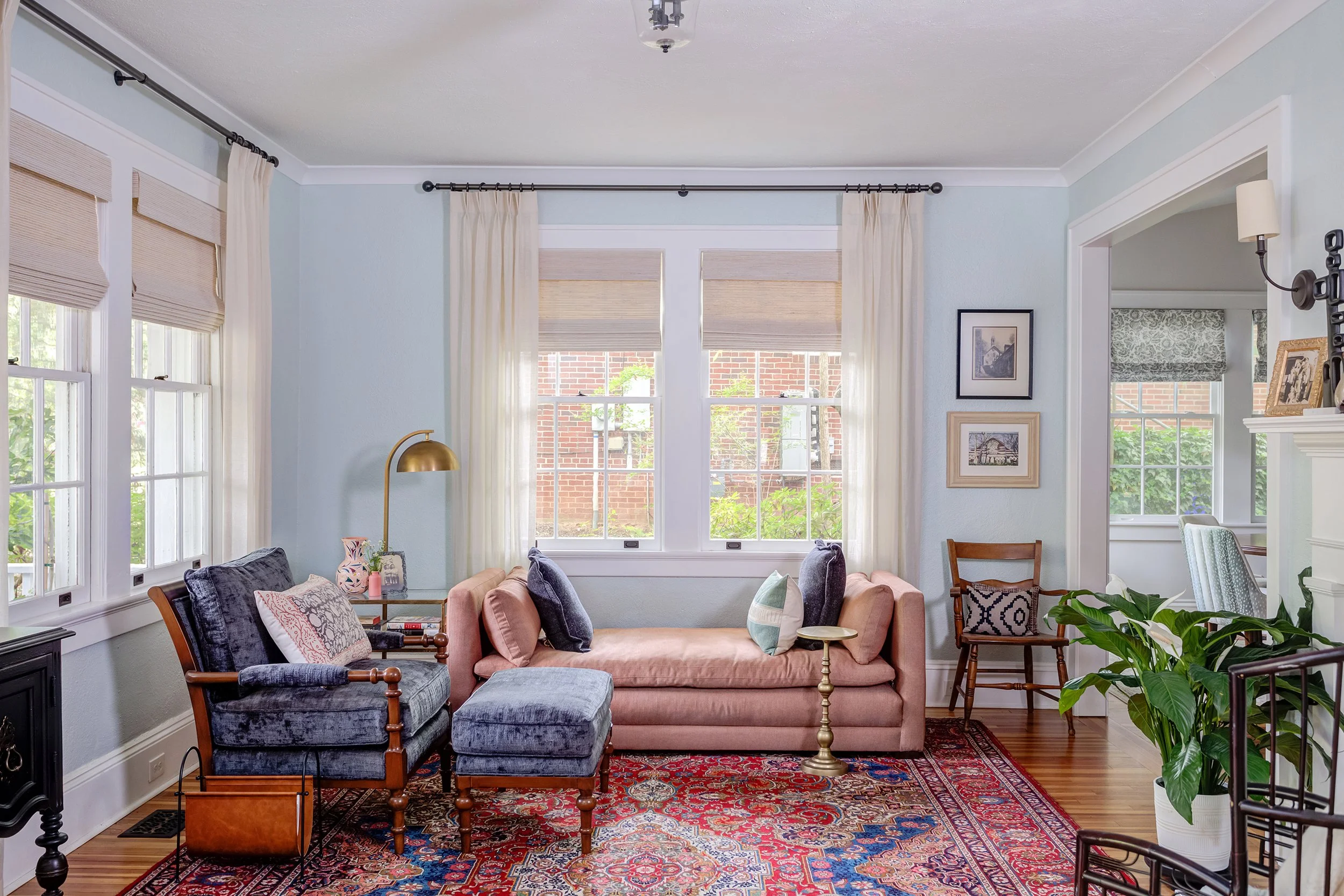 living room with blue walls and colorful persian rug blue armchair and pink chaise lounge designed by cat french design chapel hill interior designer durham interior designer