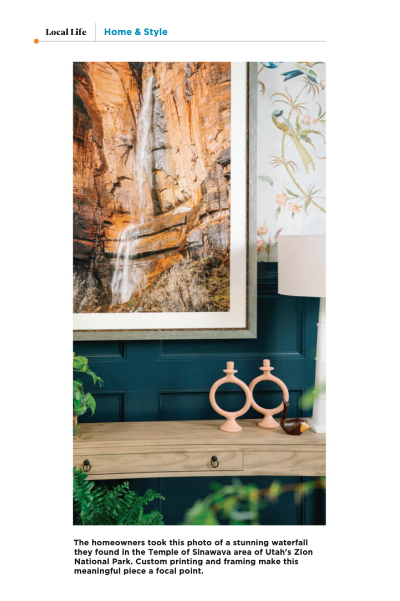 image of a framed photograph of a waterfall in zion national park in a dining room with deep blue wainscoting and bird patterned wallpaper designed by cat french design chapel hill interior designer