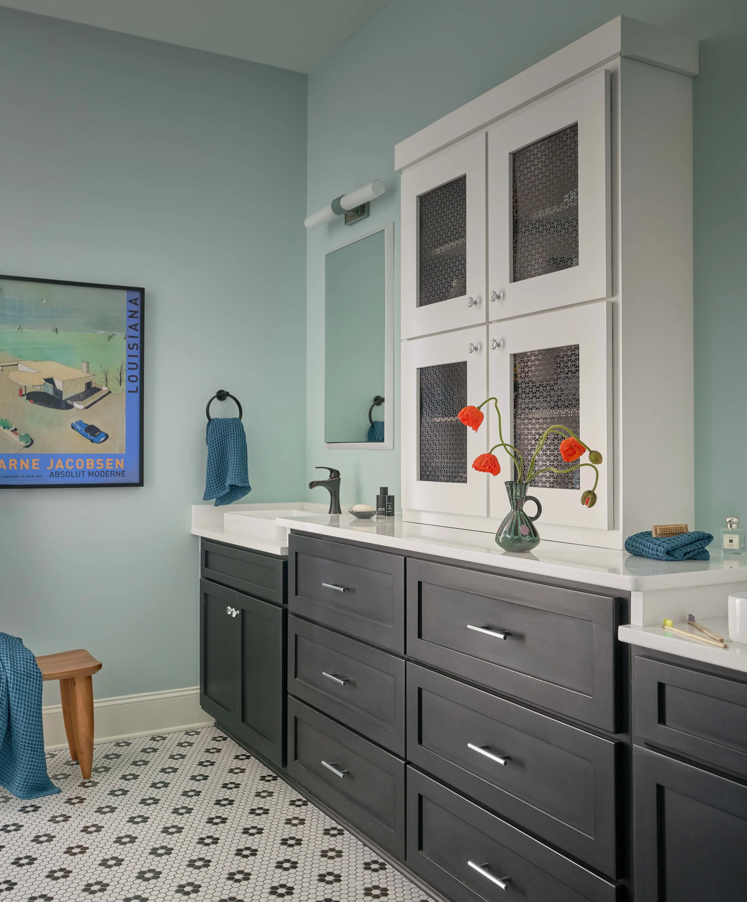 primary bathroom design with light blue walls white cabinetry and black and white tile floor for chapel hill home design mid-century style cat french design luxury interior designer chapel hill, NC