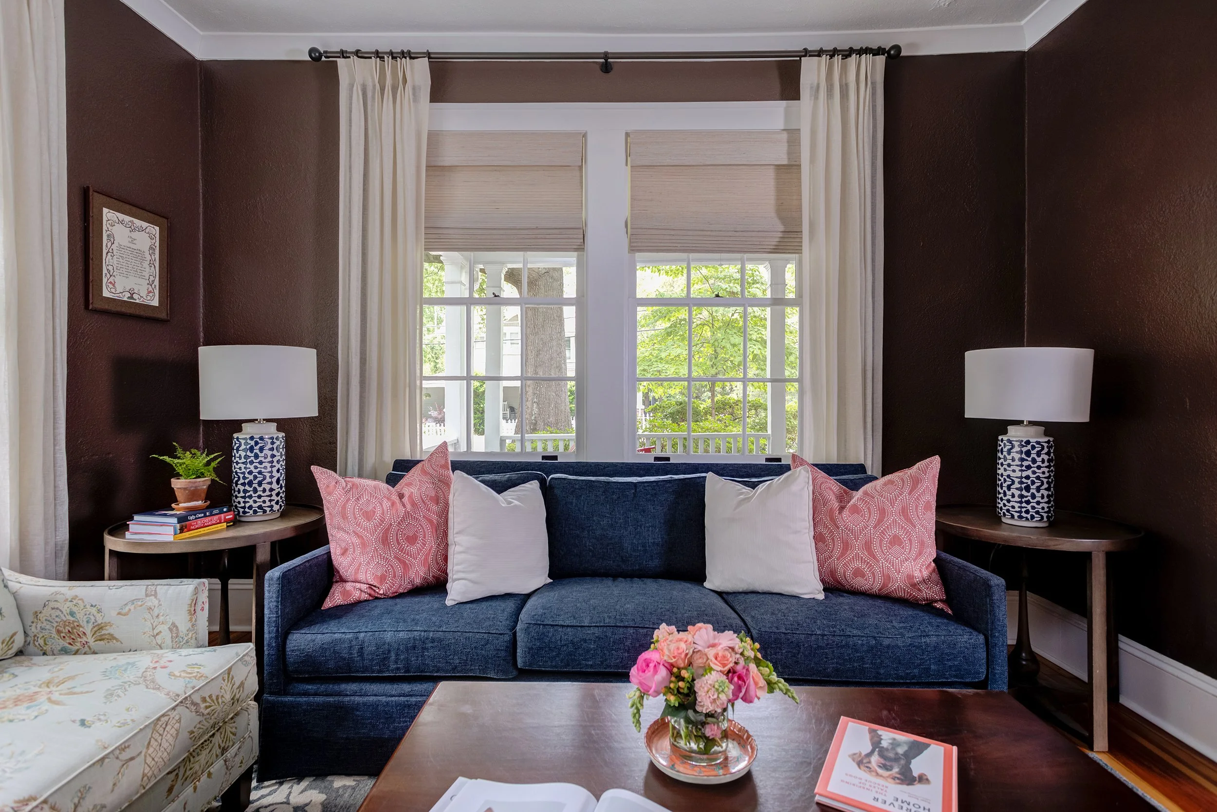 cozy room with chocolate brown walls blue couch side tables and blue lamps designed by cat french design chapel hill interior designer chapel hill historic home design durham interior designer