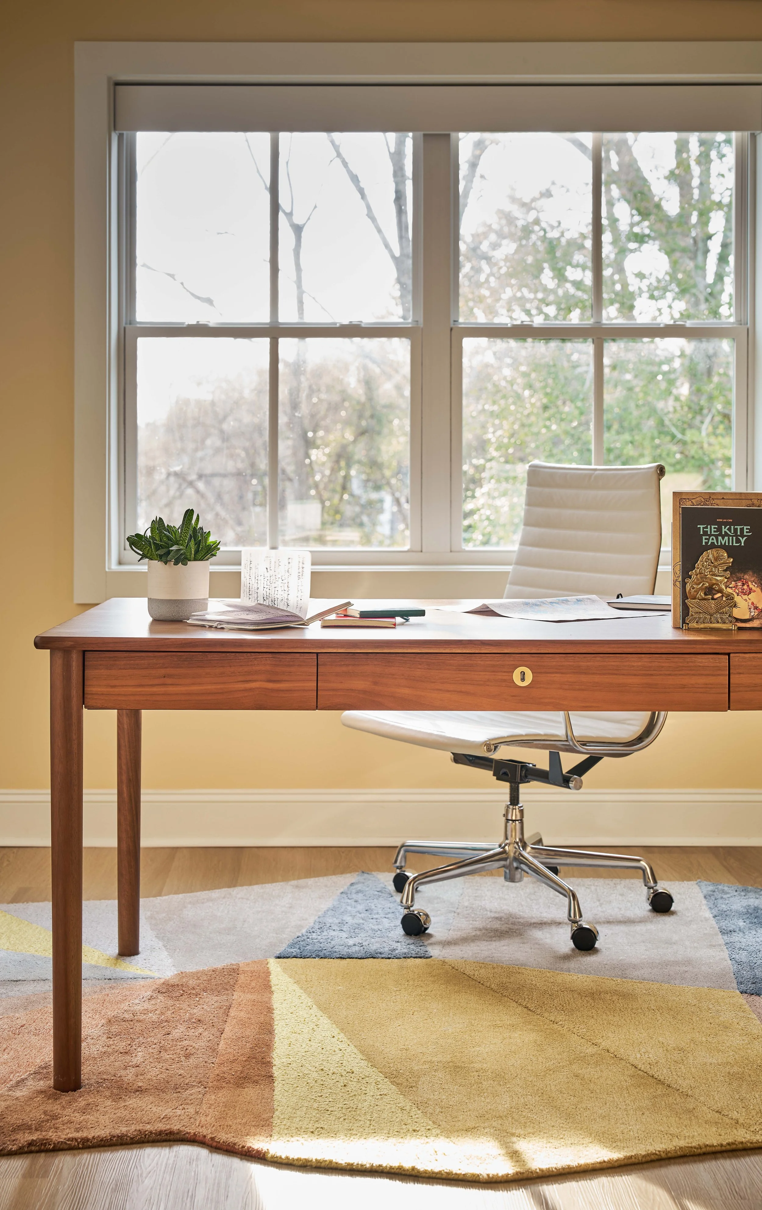 modern home office design with mid-century modern desk and geometric rug in colorful mid-century home design by cat french design chapel hill interior design warm luxury interiors
