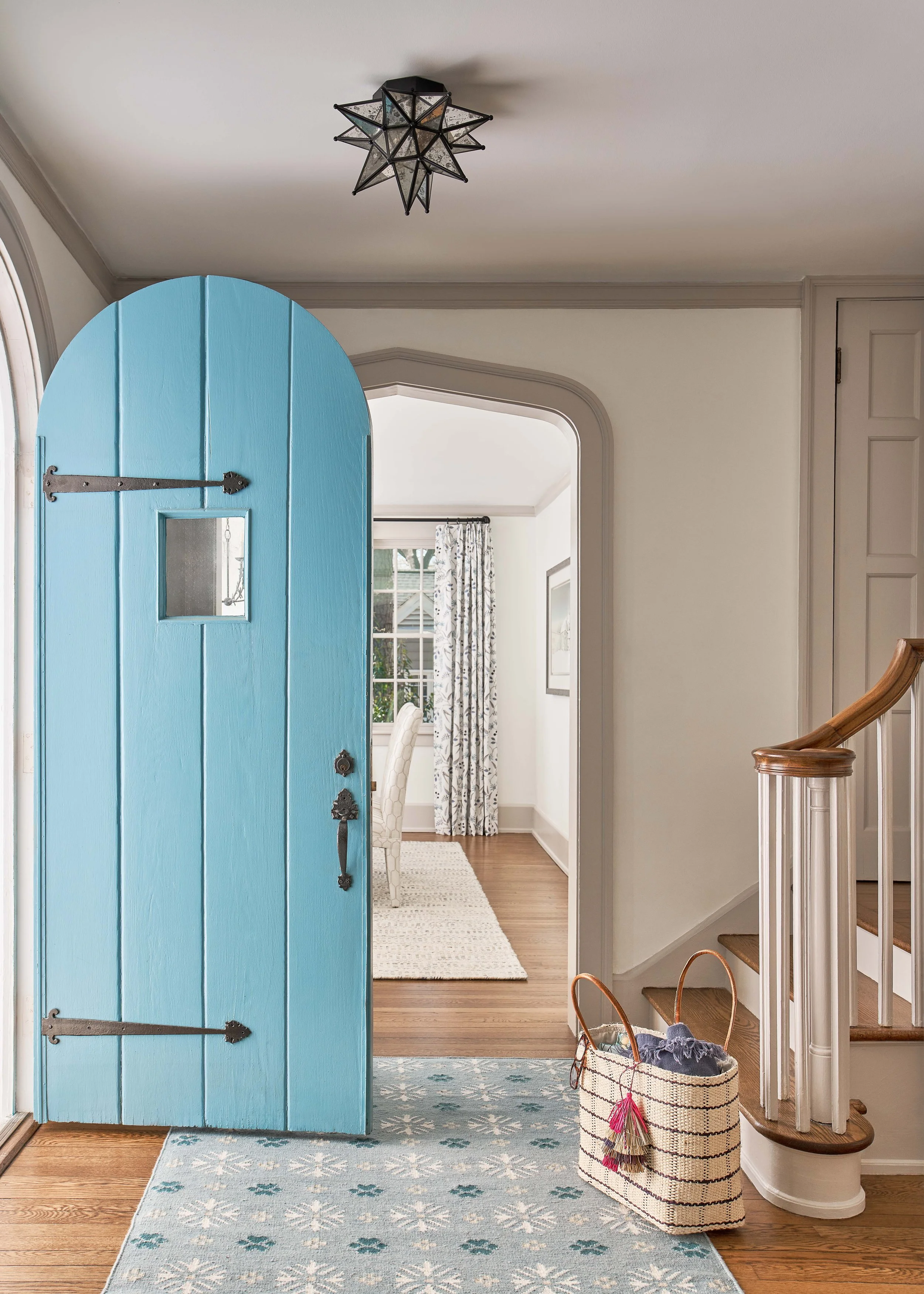 blue door of a historic chapel hill home looking into dining room interior design by cat french design chapel hill durham interior design