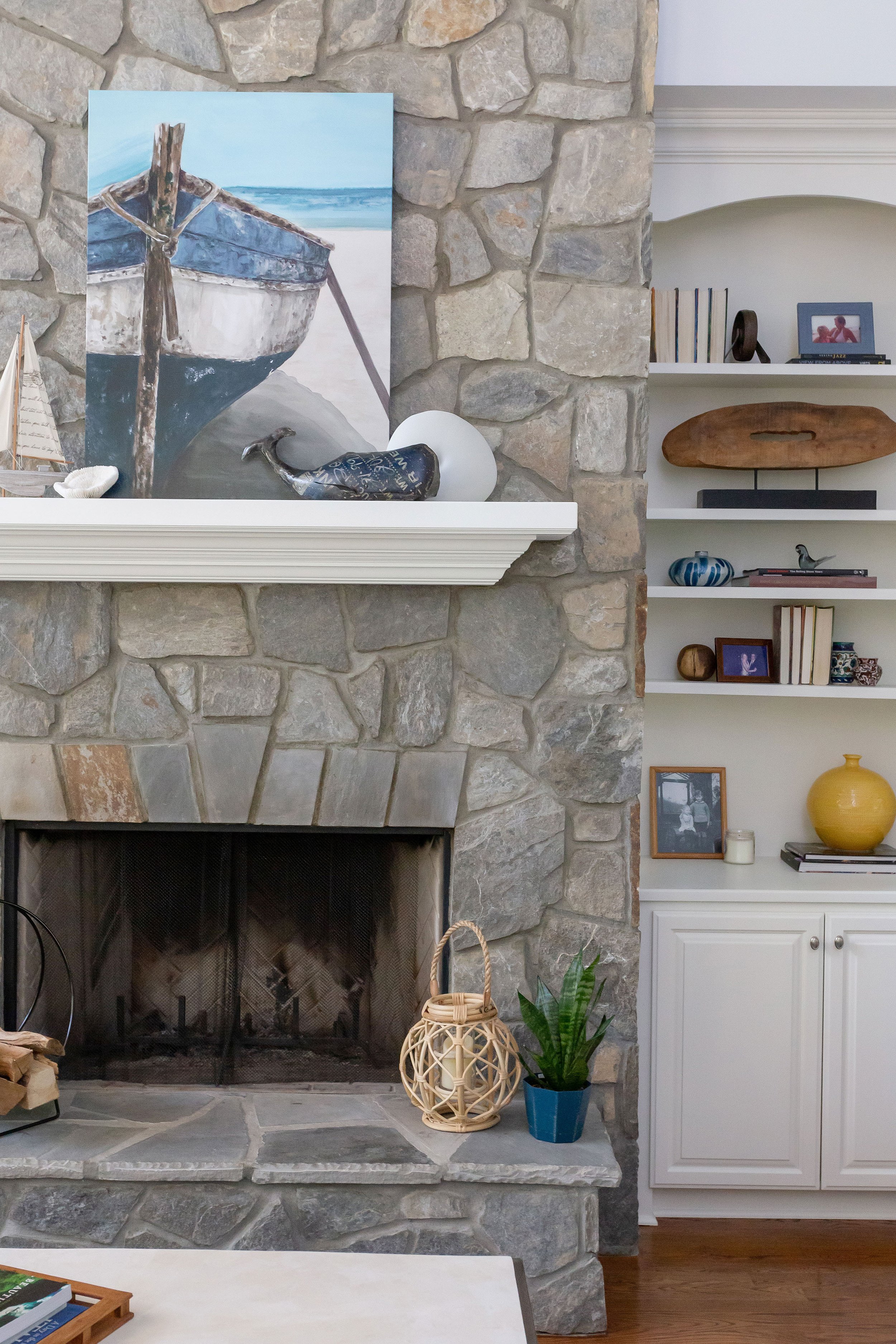 tall stone fireplace with coastal art and decor in contemporary coastal living room design durham north carolina home design durham interior designer chapel hill interior designer cat french design