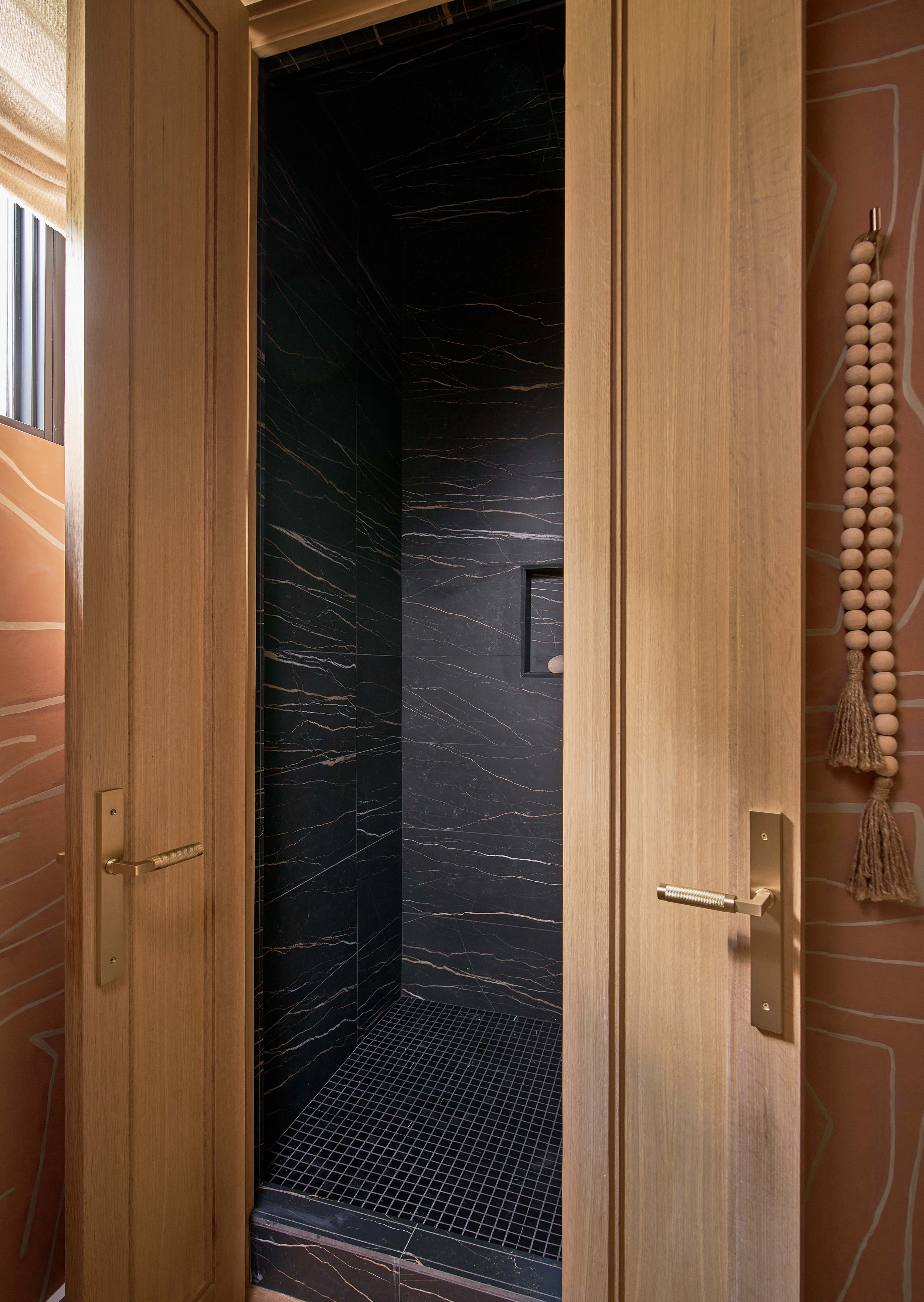 a black marble tiled shower with double doors hidden shower modern shower black tile shower modern luxury homes contemporary home design chapel hill nc durham nc cat french design luxury interior design firm north carolina