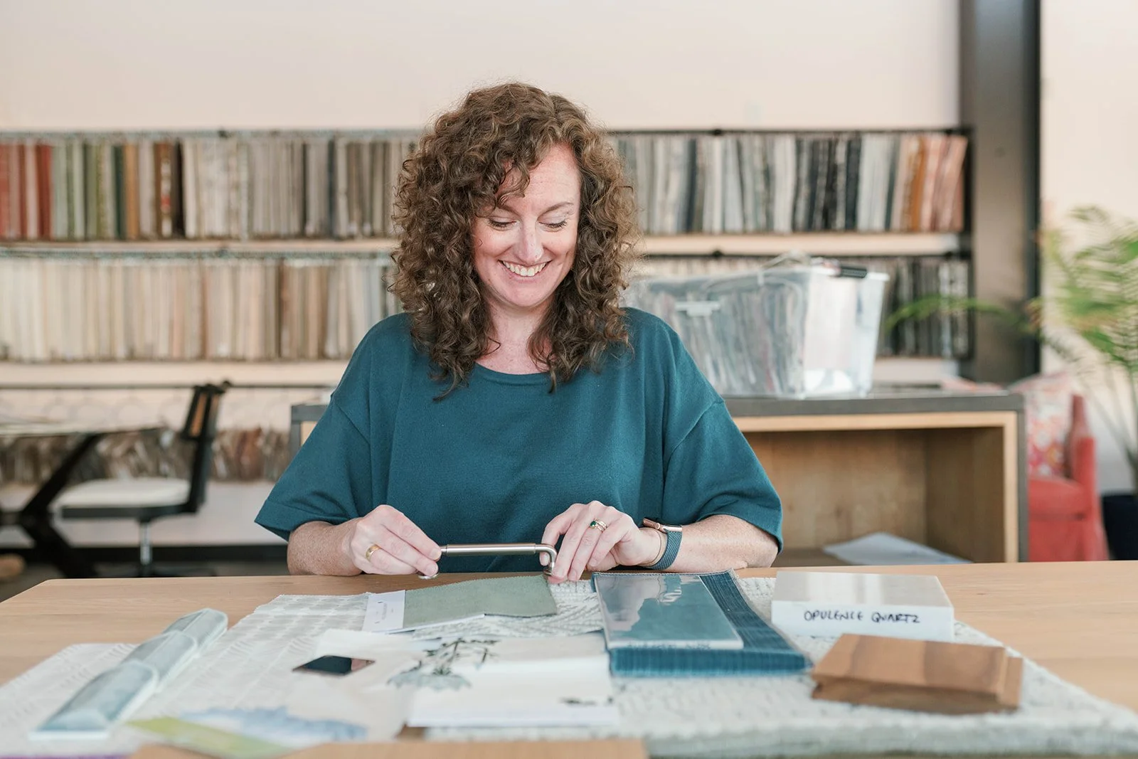 cat french chapel hill interior designer sitting at a table with fabric and tile samples in her interior design studio in southern village chapel hill