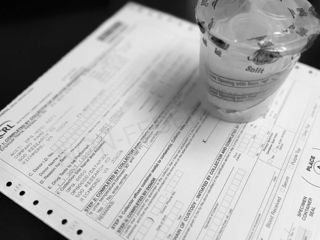 Drug Test Chain of Custody form and urine collection cup