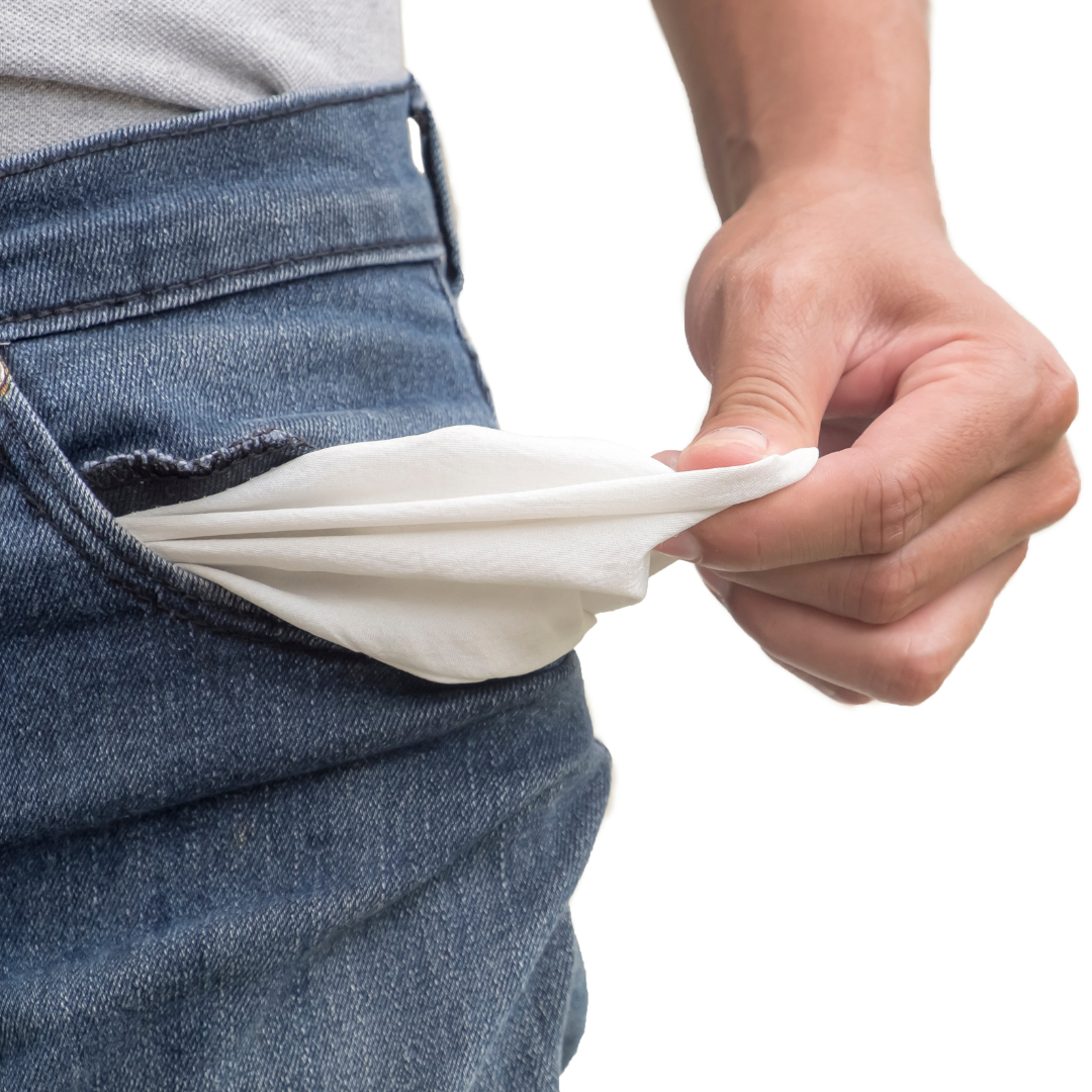Close-up of a person's hand pulling out a white face mask from their front pocket of blue jeans.