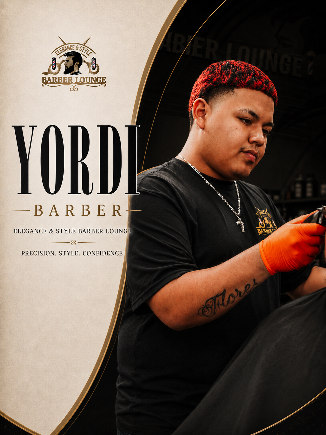 Young man in black barber lounge t-shirt standing in front of a grey wall with a beard silhouette logo and a barber pole design.