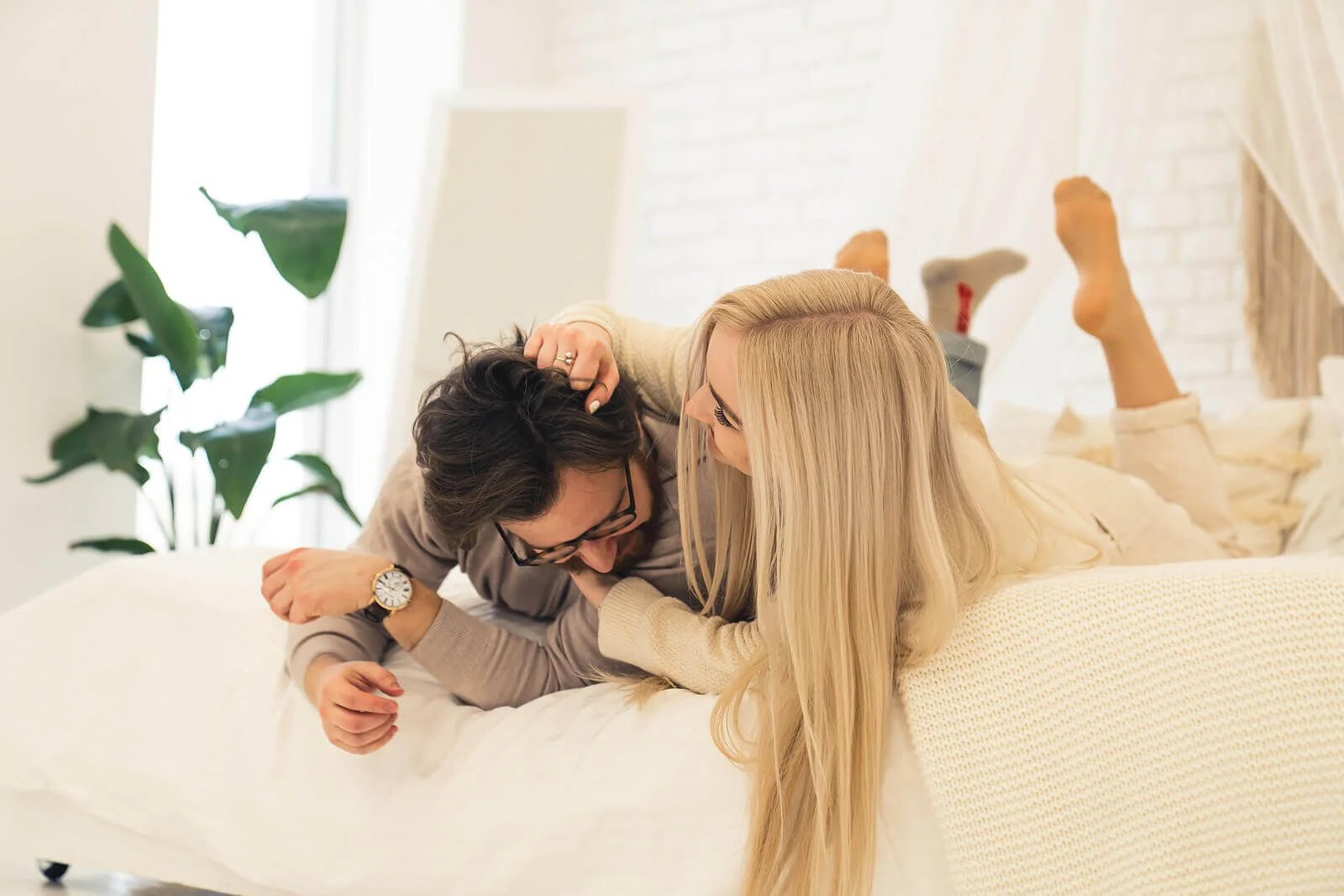 A couple laughing in bed together