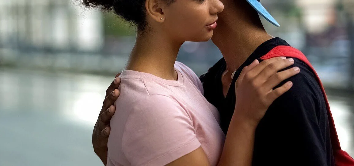 A couple hugging outdoors