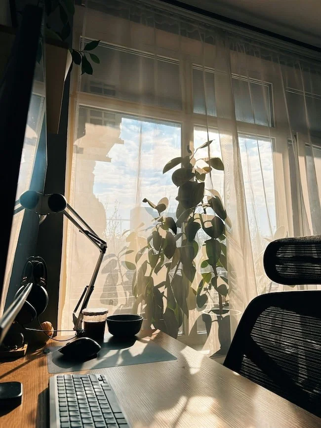 Minimal desk with scattered objects in soft morning light