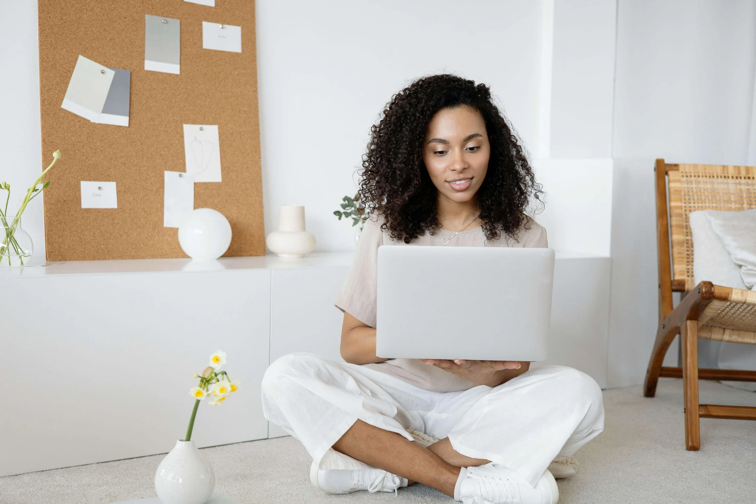 A woman sitting on the floor, looking thoughtful