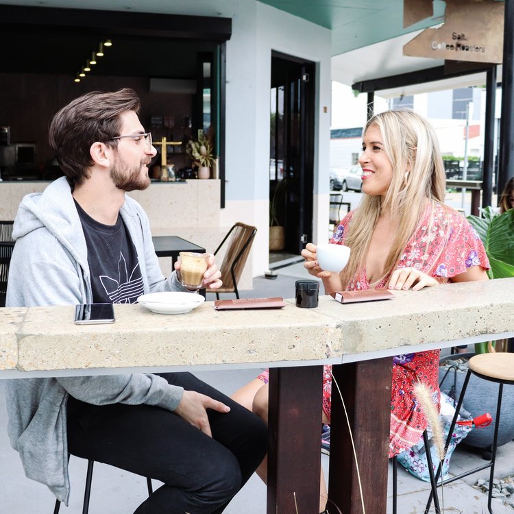 A couple sipping coffee at a cafe