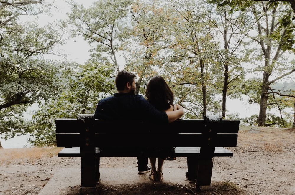 Couple sitting on a bench outside