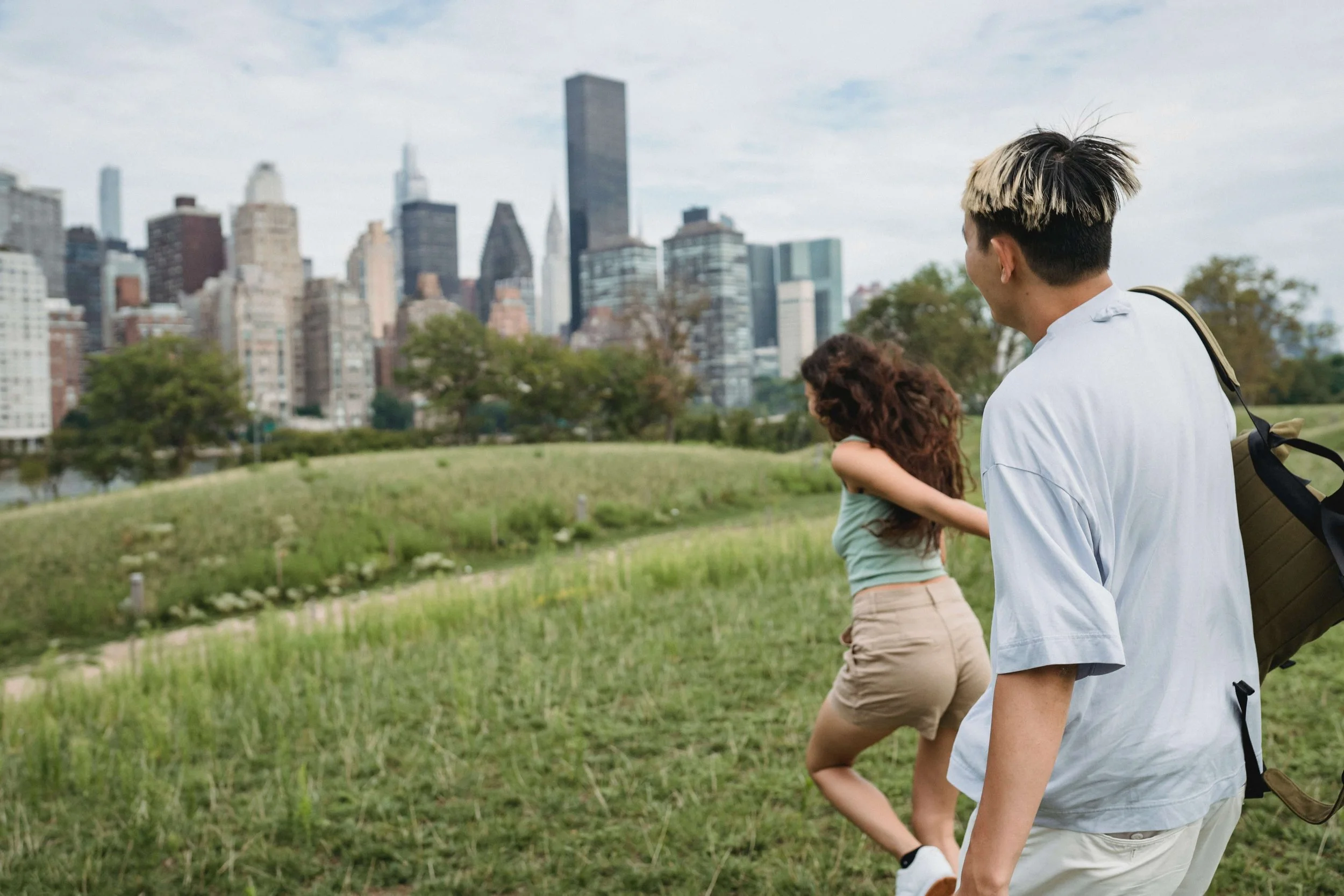 Two people holding hands in a New York City park