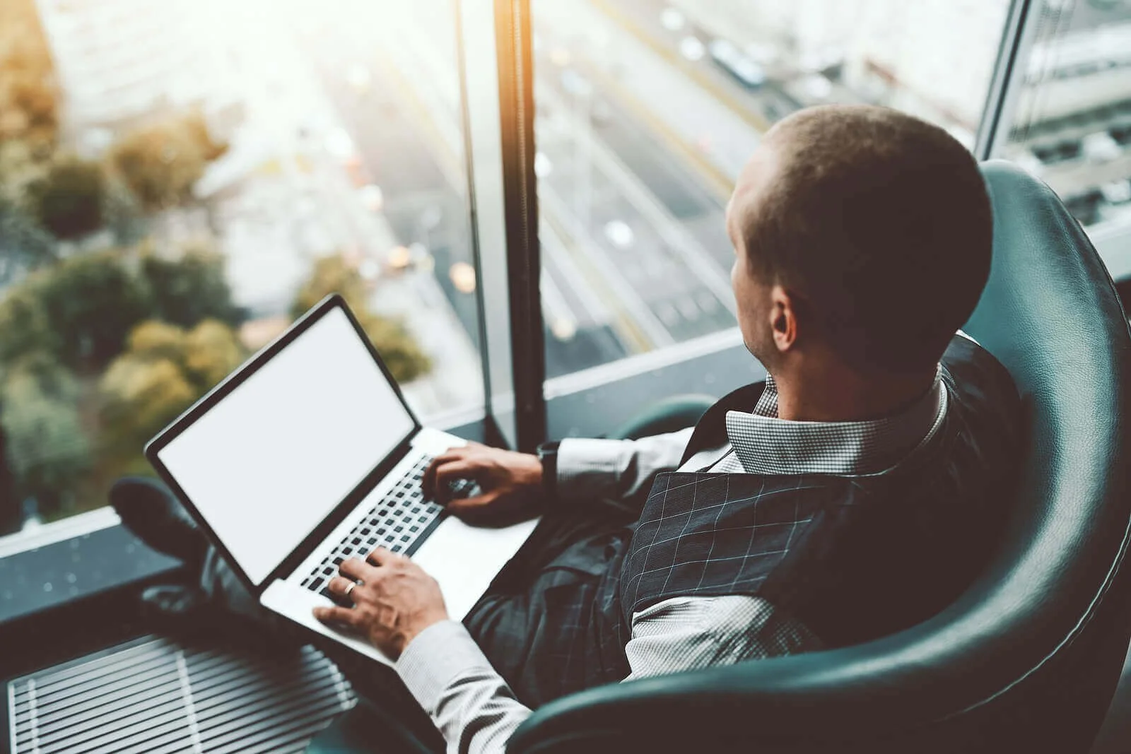 A man working on a laptop in an office building