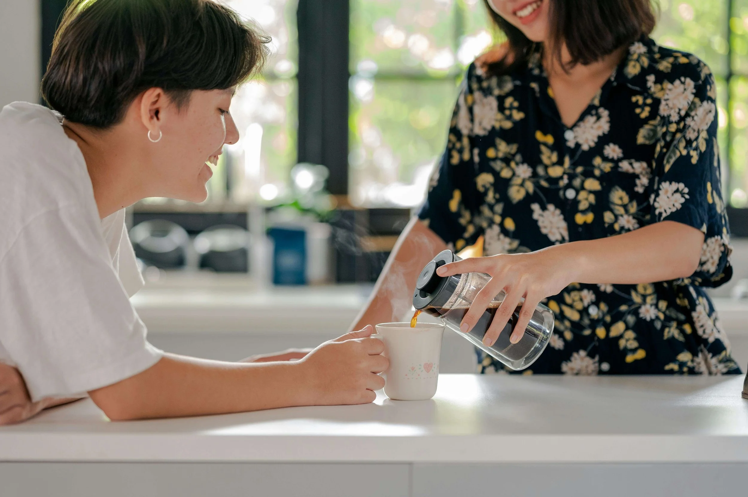 A couple talking quietly together in a kitchen