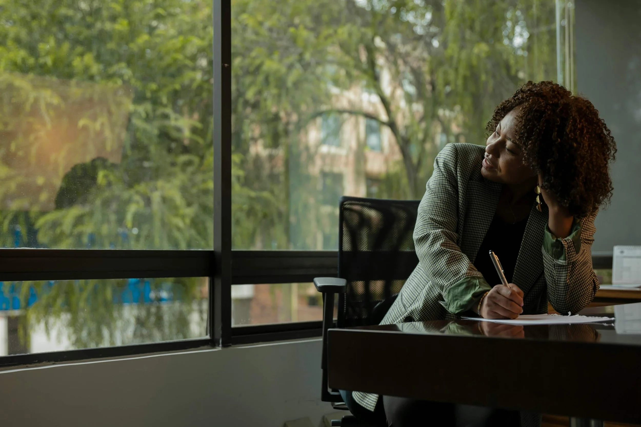 Businesswoman looks out conference room window