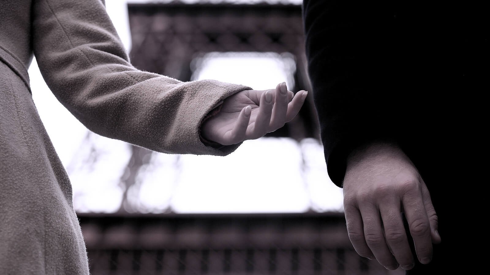 a couple reaching toward each other