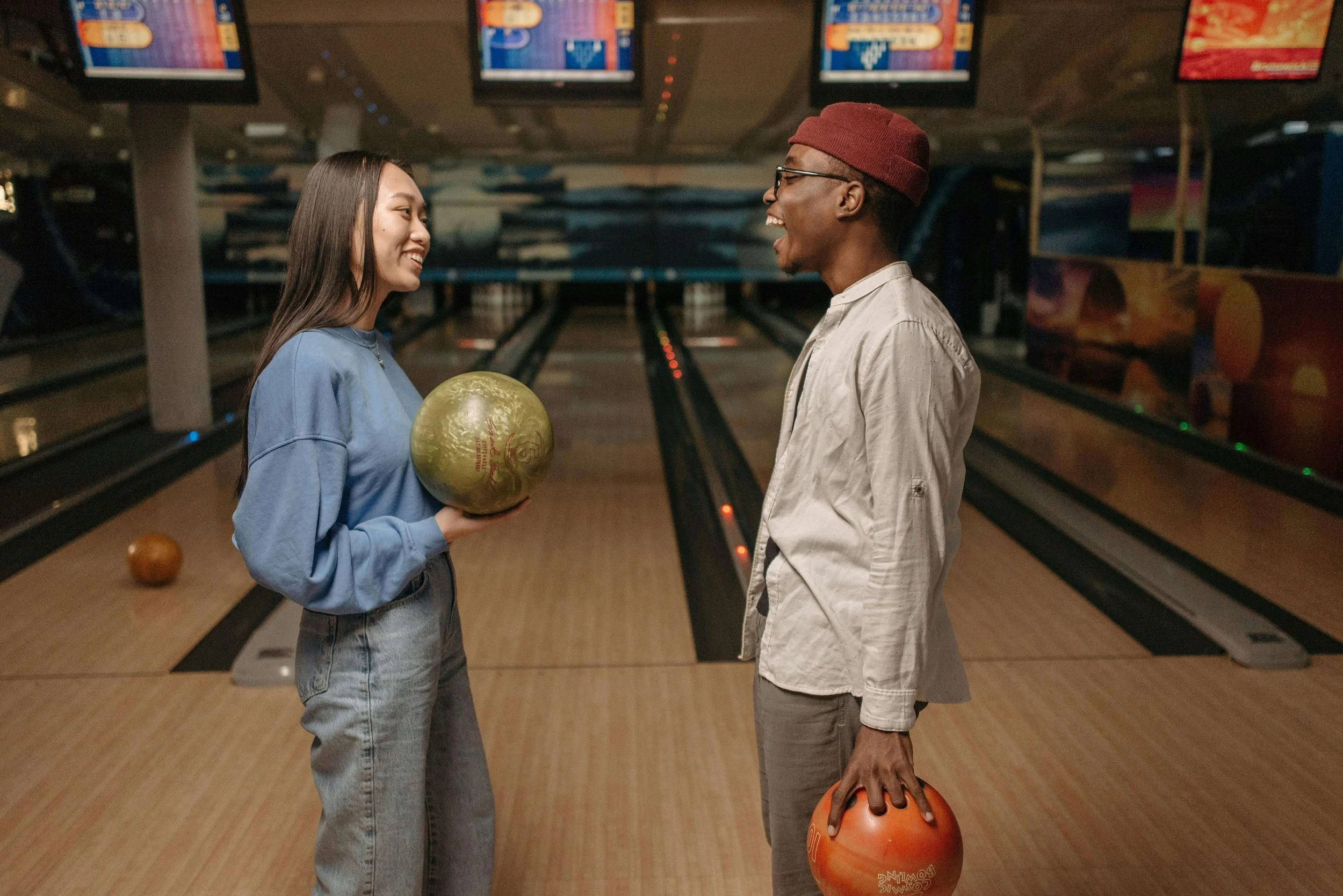 A couple laughing together at a bowling alley