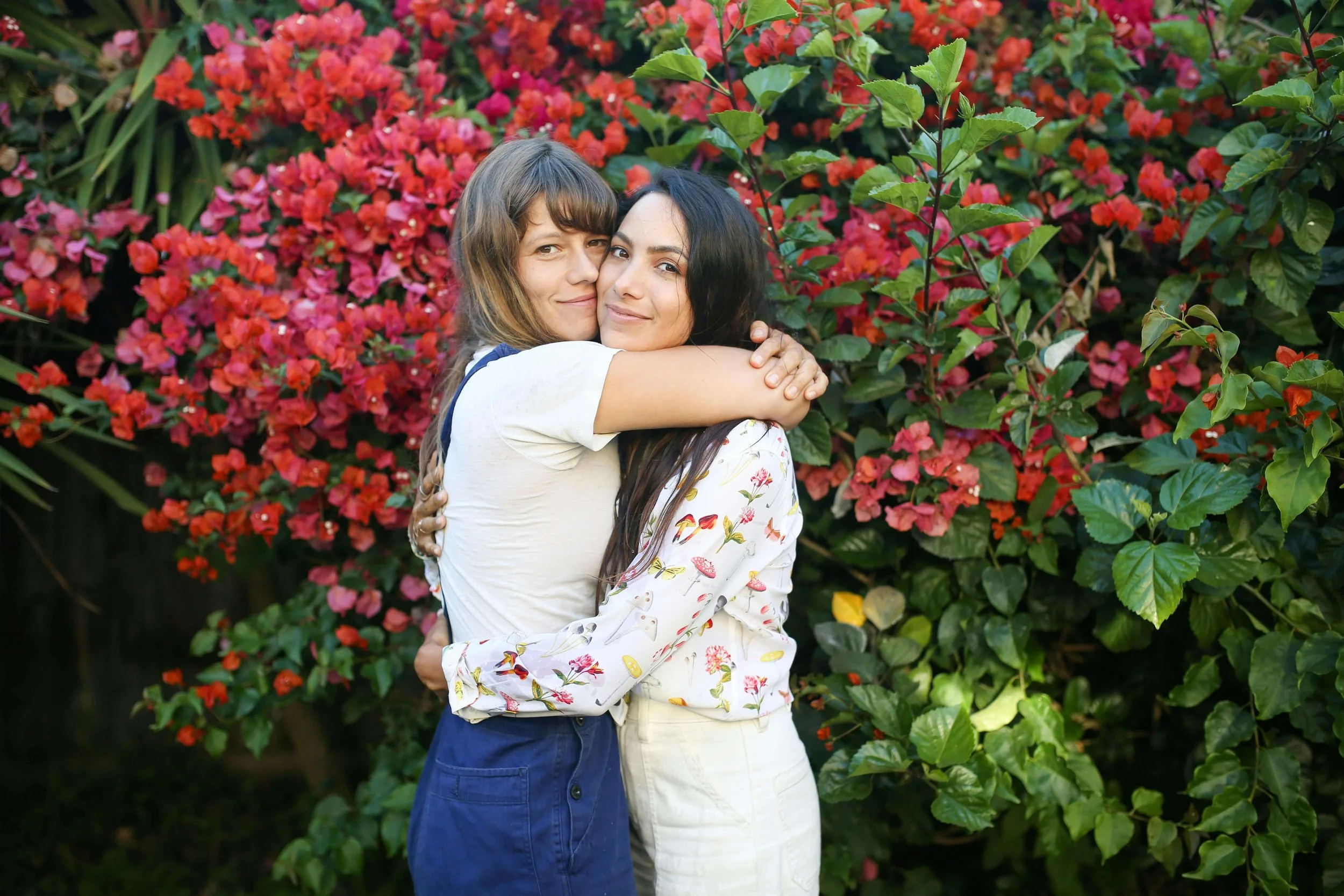 A couple smiling and embracing outdoors