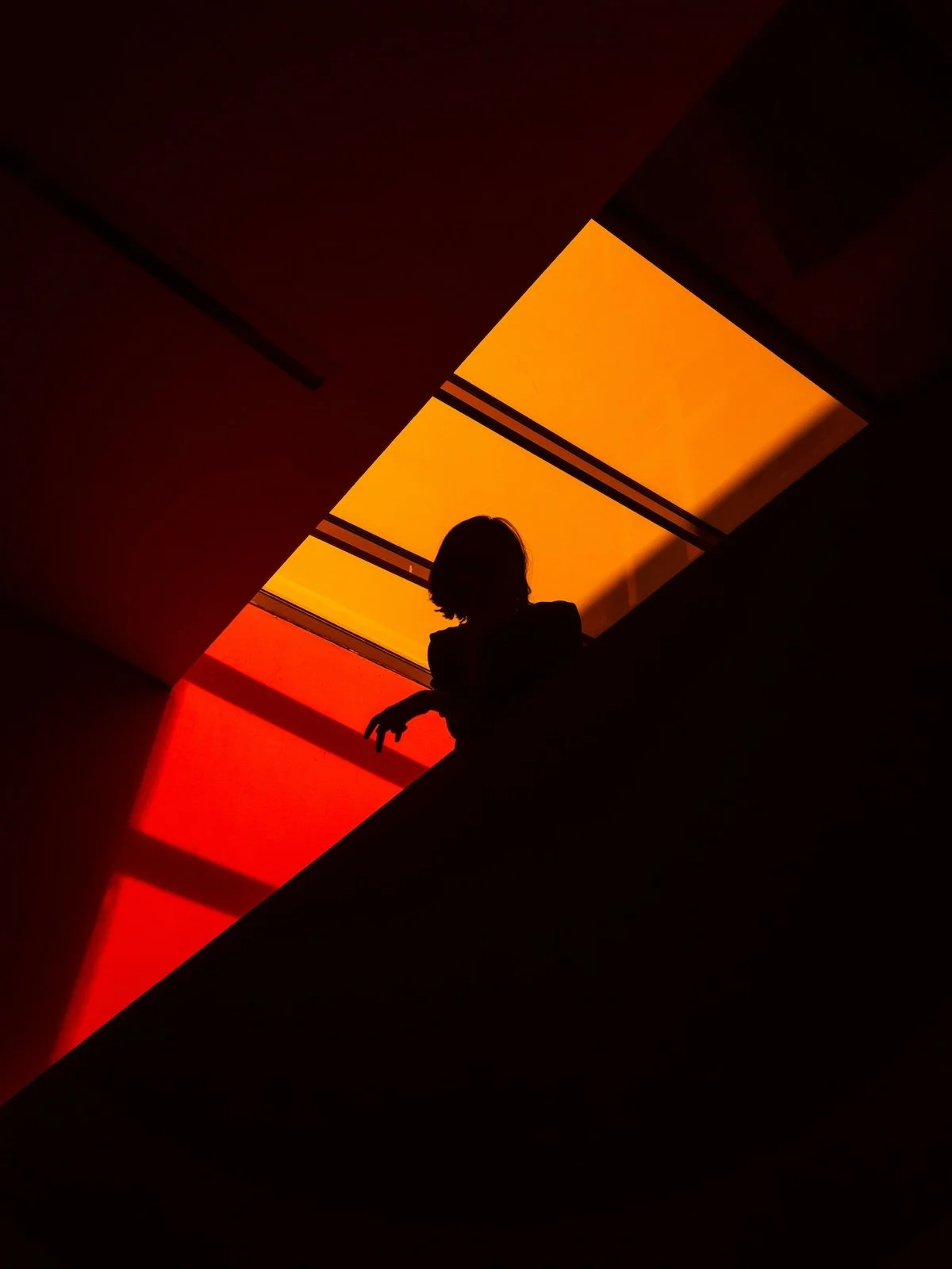 Silhouette of a woman in orange light