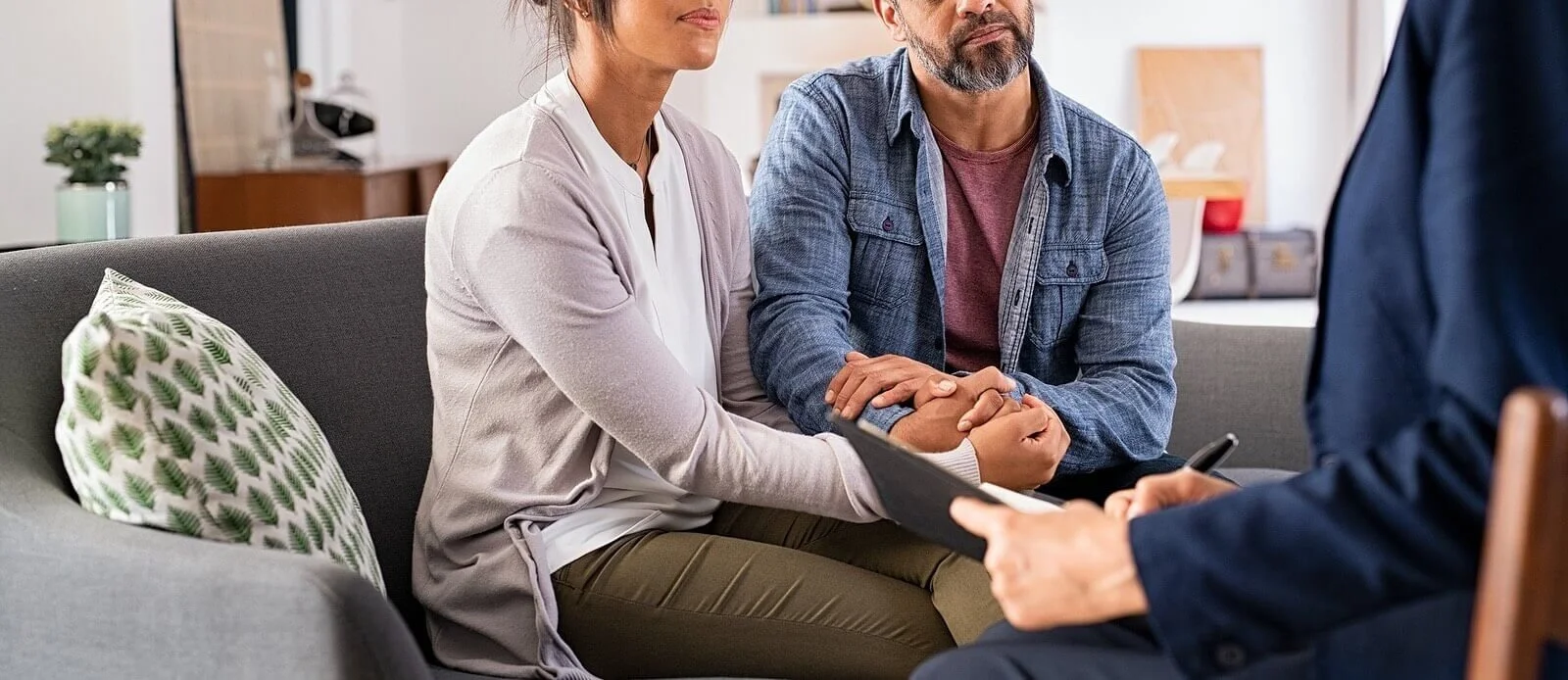 An older couple sitting on a couch during a couples therapy session
