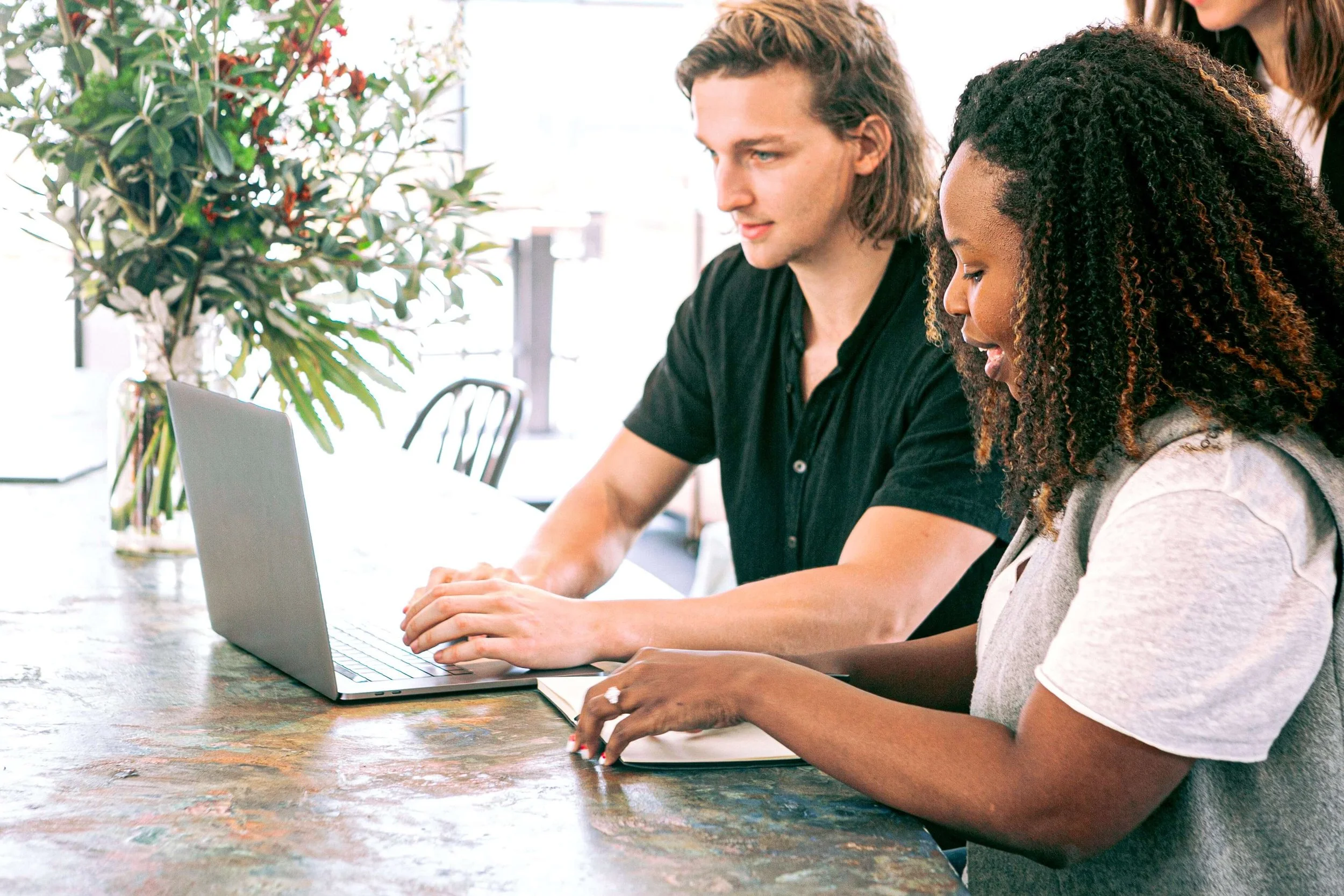 Two people working together at a desk