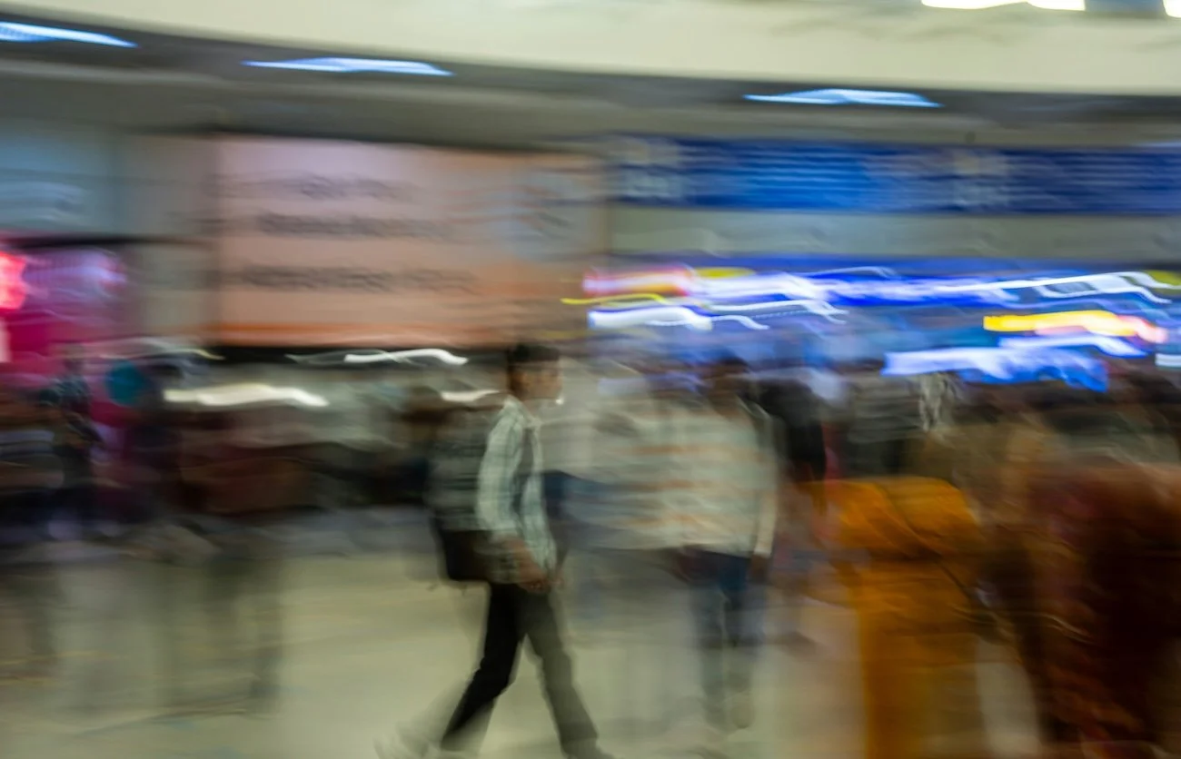 Person walking through a structured hallway with motion blur