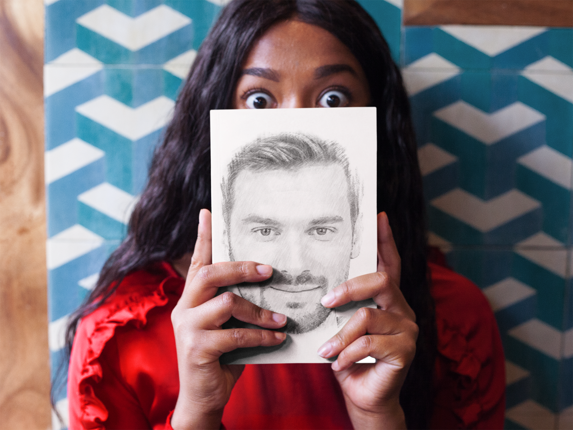 surprised-woman-holding-a-book-mockup-while-against-a-tiles-wall-a17345.png
