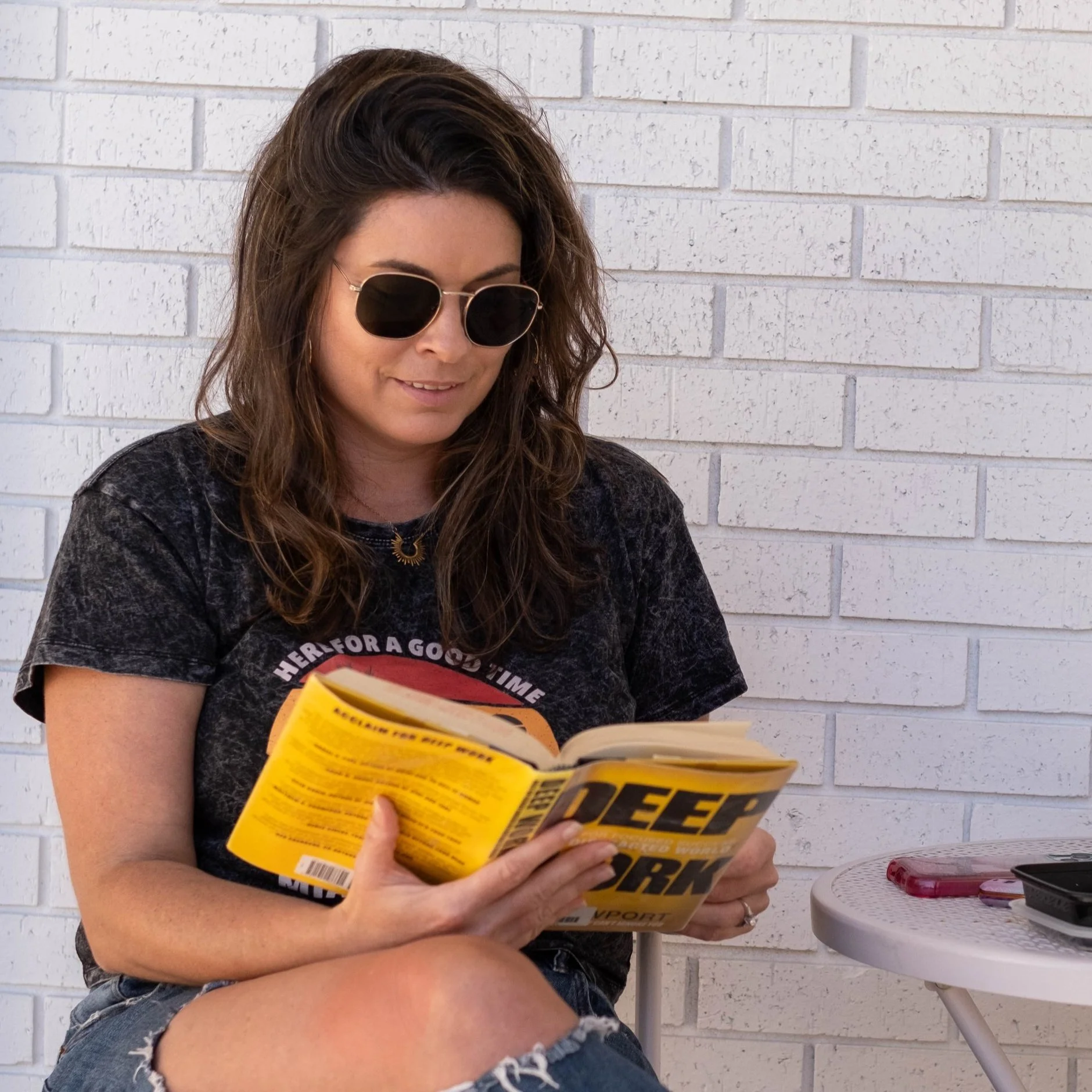 girl reading a book outside the flamingo house